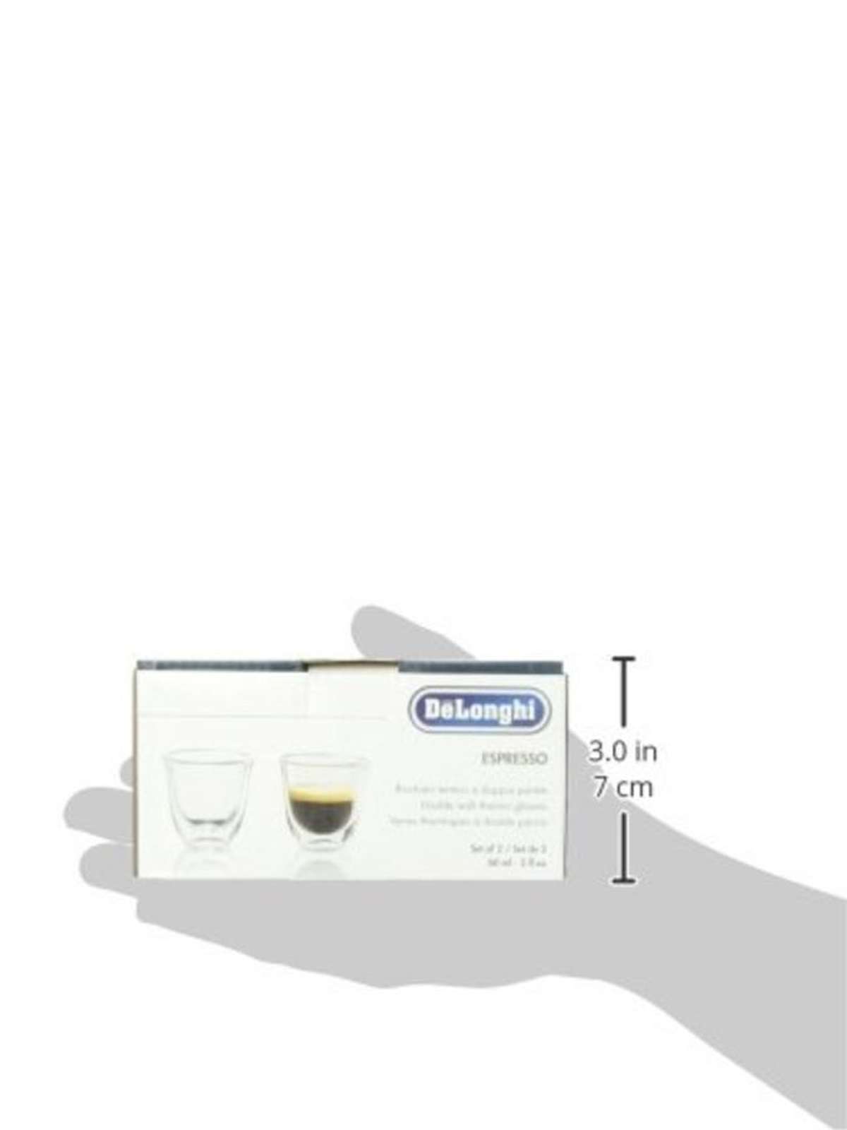 Vasos de espresso DeLonghi en una caja, con una mano sosteniendo la caja y una regla de 7cm.