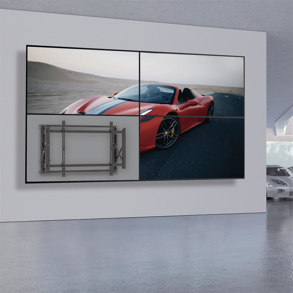 Four large TV screens showing a red car. Gray wall and floor.