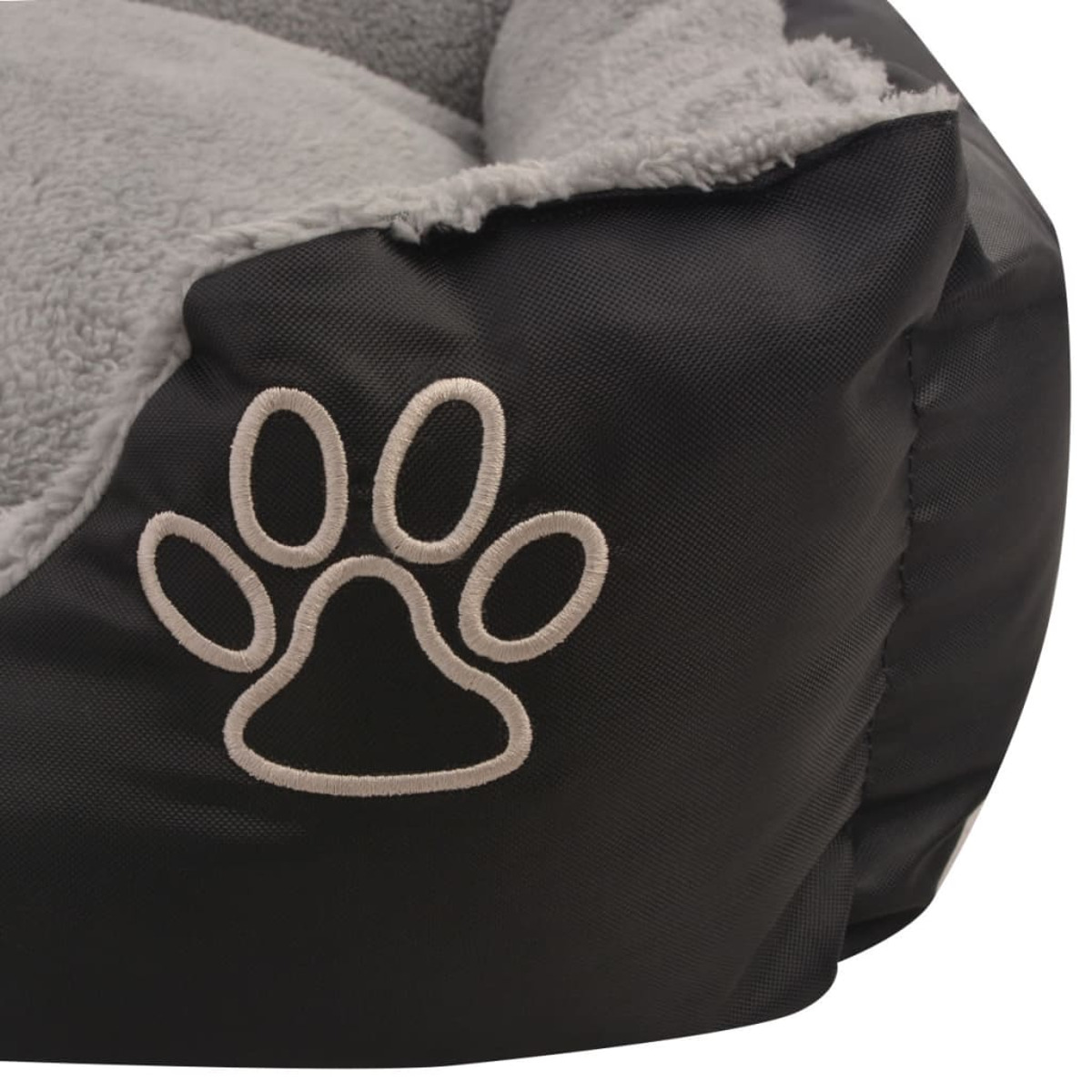 Schwarzes und graues Hundebett mit Pfotenabdruck-Stickerei. Das Bett hat ein weiches, plüschiges Innenleben.
