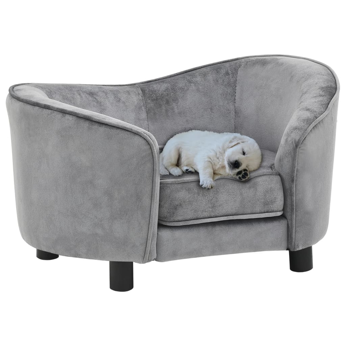 Ein kleines graues Hundebett mit einem schlafenden Welpen darin. Der Welpe ist weiß mit schwarzen Pfoten.