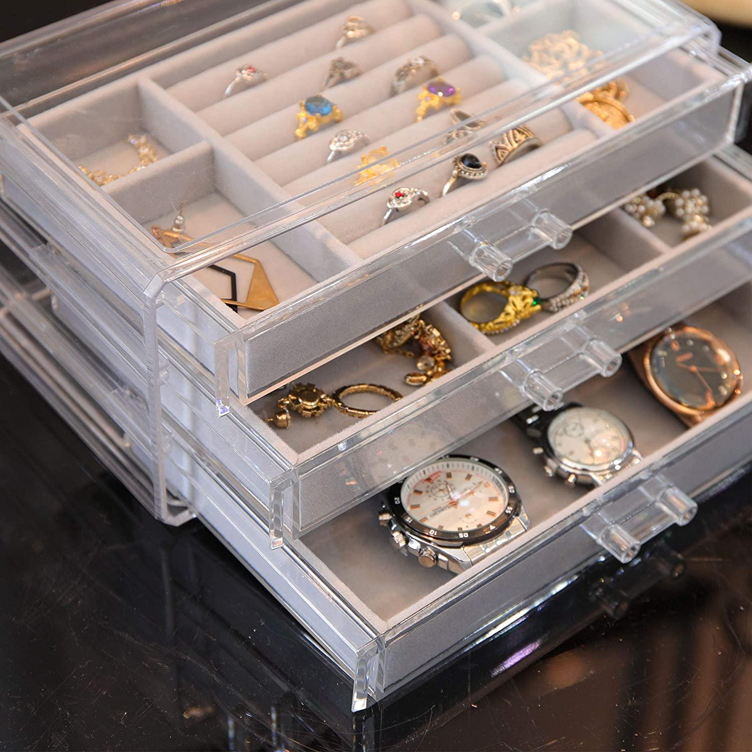 Schmuck-Organizer mit zwei Schubladen voller Ringe, Uhren und anderem Schmuck.