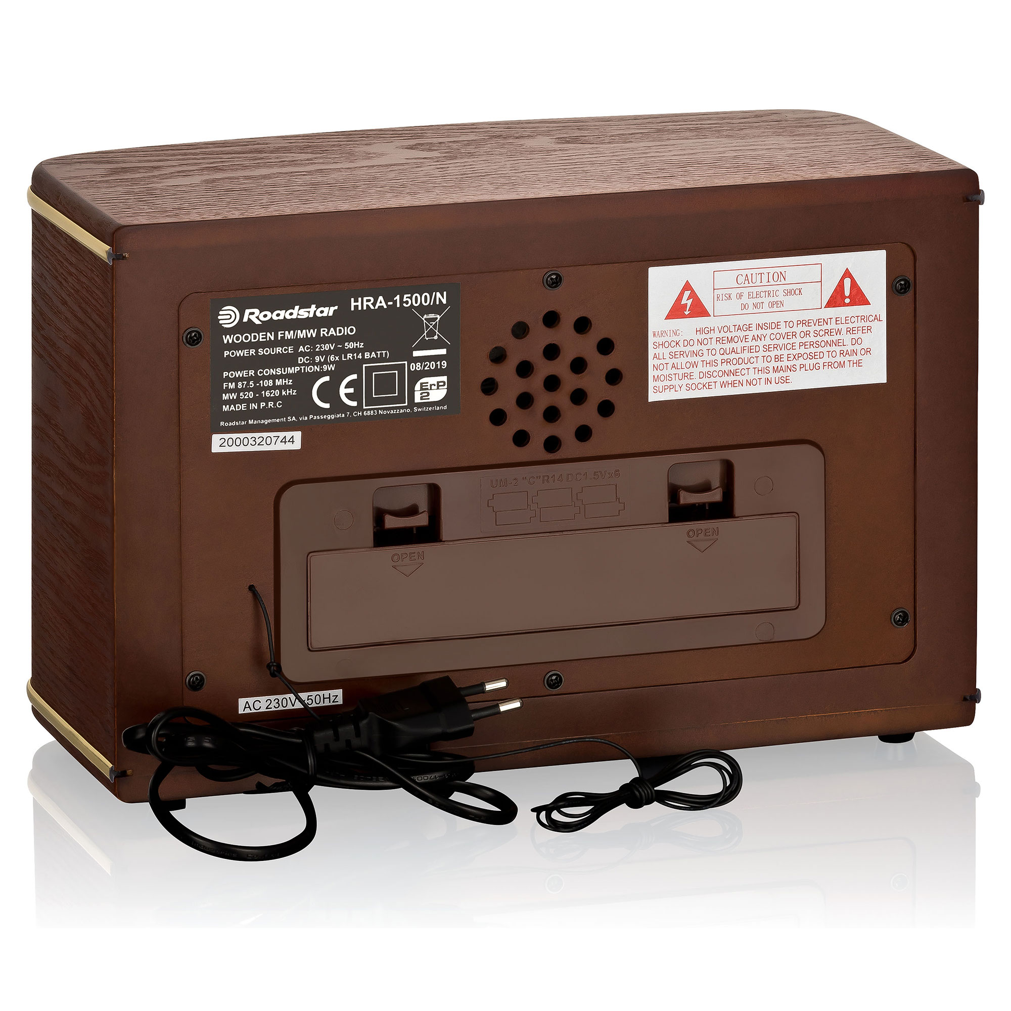 Brązowe radio retro z kablem zasilającym i etykietą z tyłu. Ma głośnik i elementy sterujące.