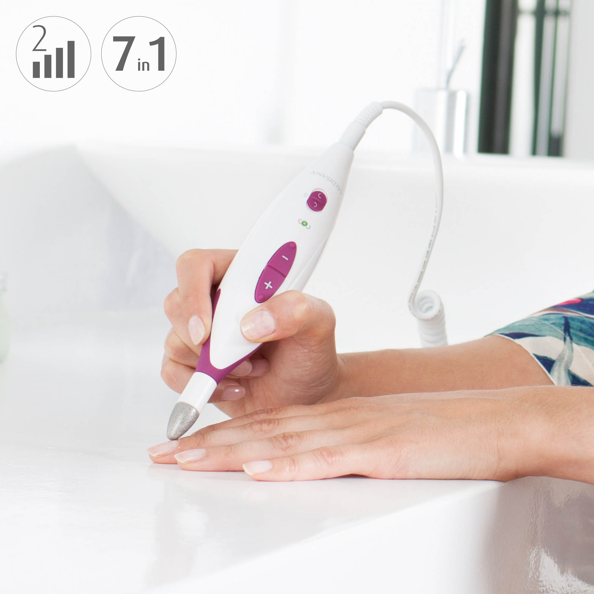 A woman's hand holding a white and purple 7-in-1 beauty device over a sink.