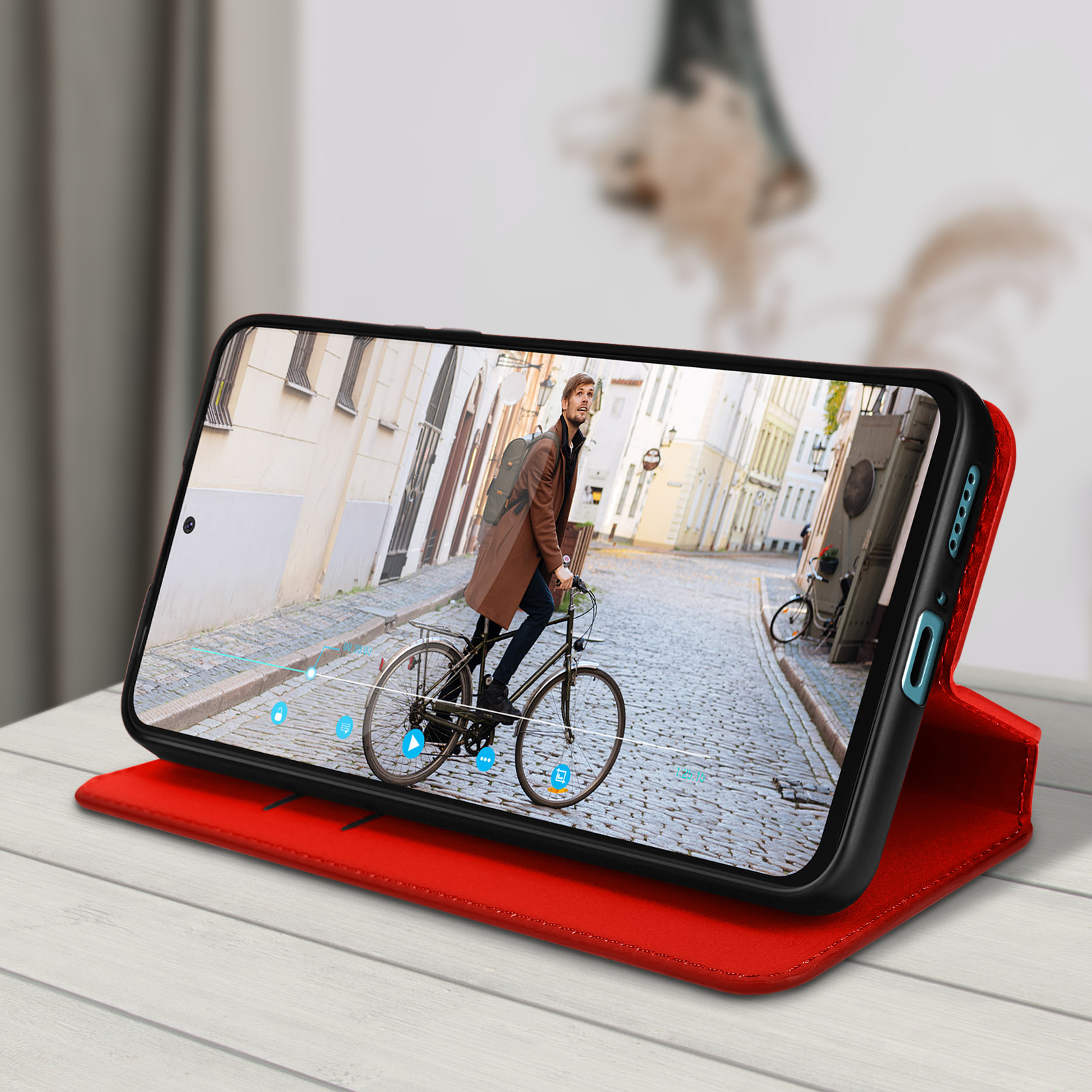Telefono in custodia rossa su custodia aperta rossa. Video in riproduzione sullo schermo. Strada europea.
