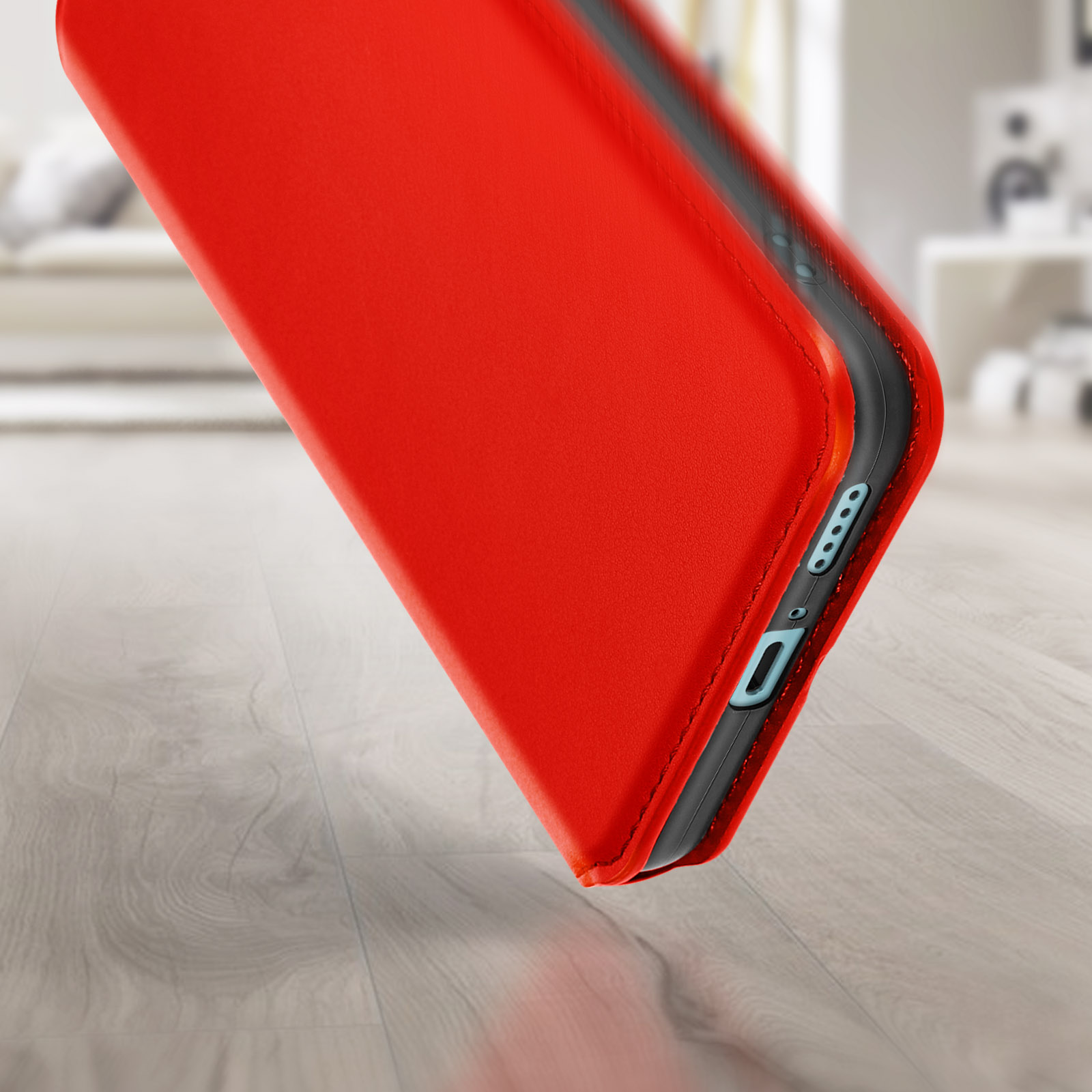 Custodia rossa per telefono con cornice nera. La custodia è aperta. Lo sfondo è un pavimento in legno.