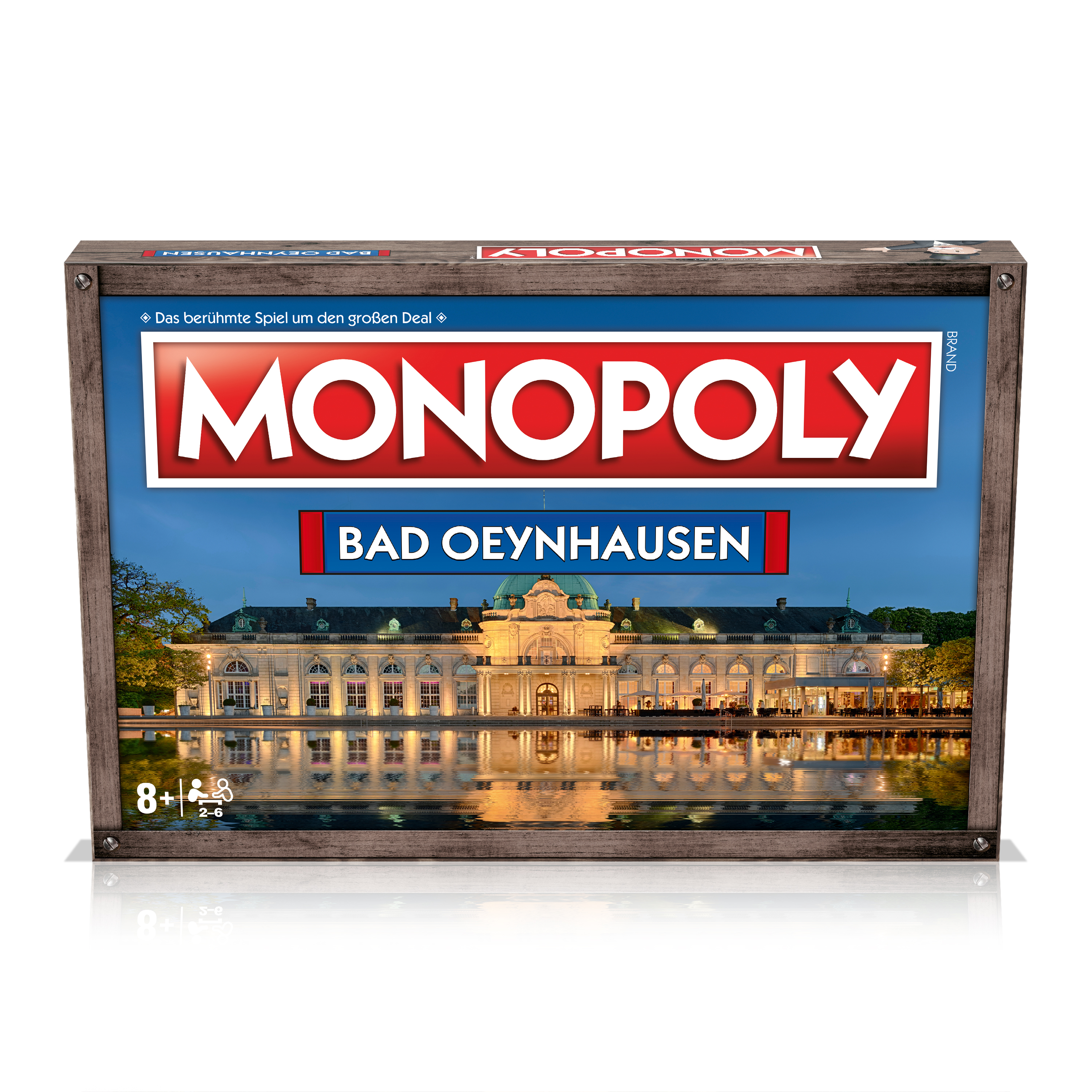Monopoly-Brettspielbox, mit Stadtbild und Reflexionen auf dem Tisch.