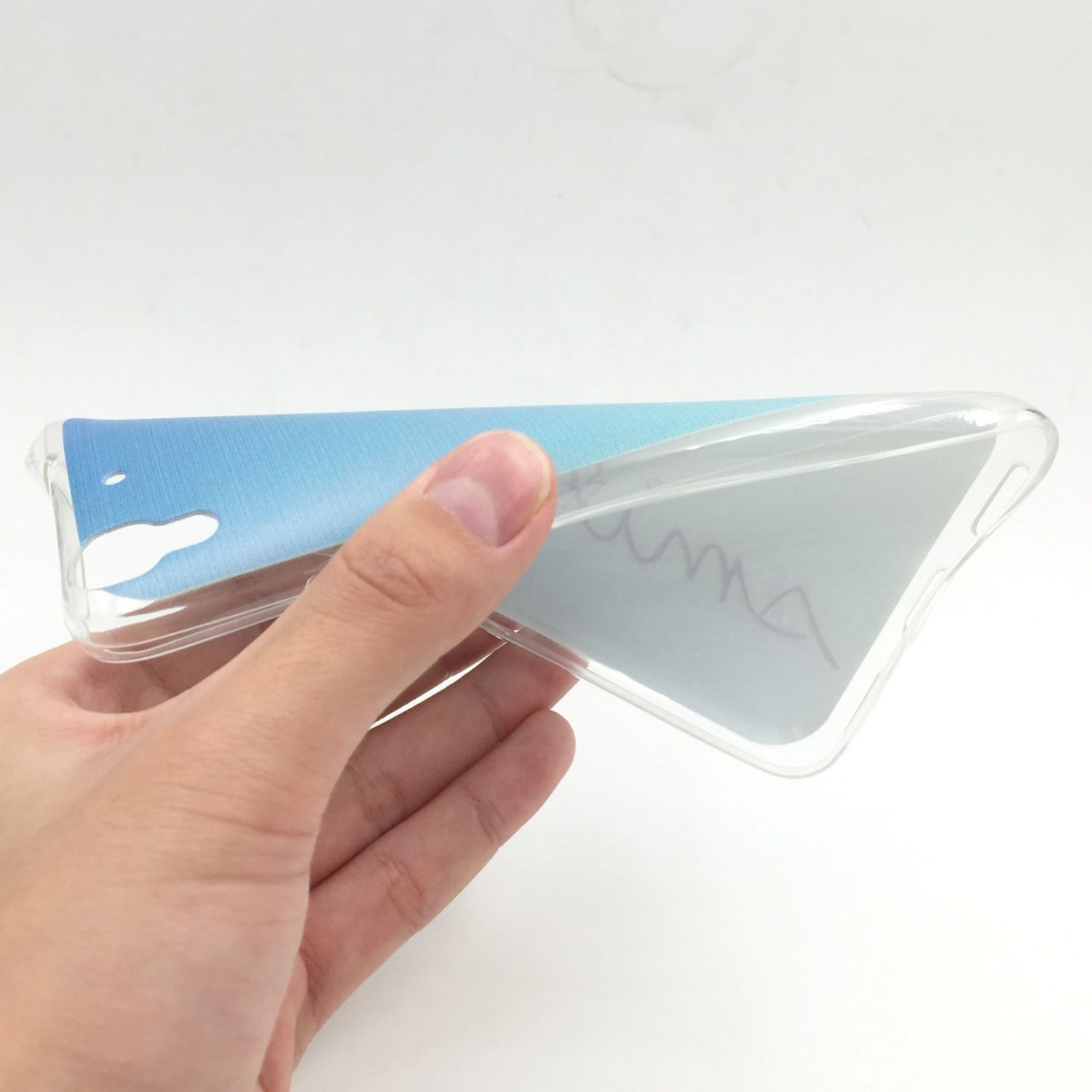 Hand hält eine transparente Handyhülle mit blauem und weißem Farbverlauf. Die Hülle ist durchsichtig.