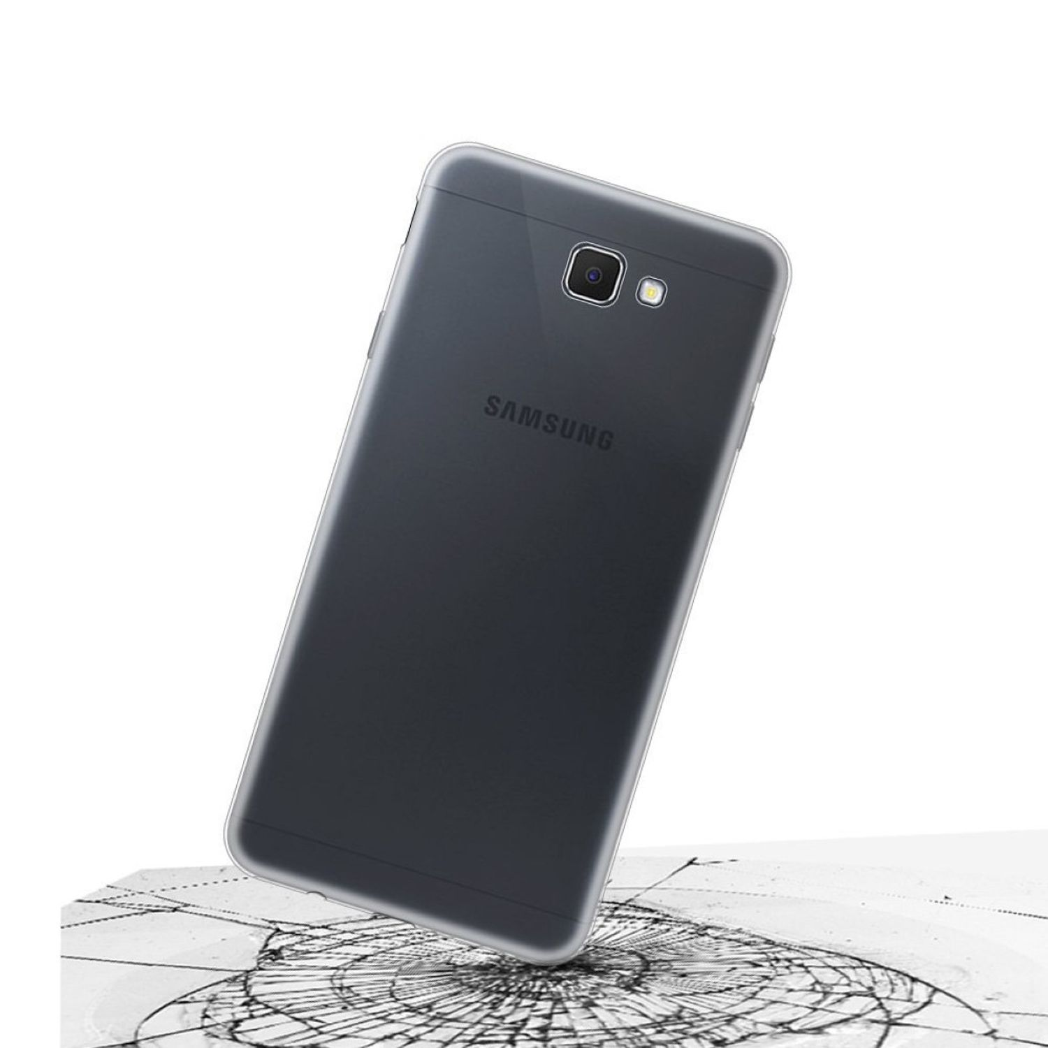 Ein Telefon liegt auf einer zerbrochenen Oberfläche, mit Samsung-Logo.