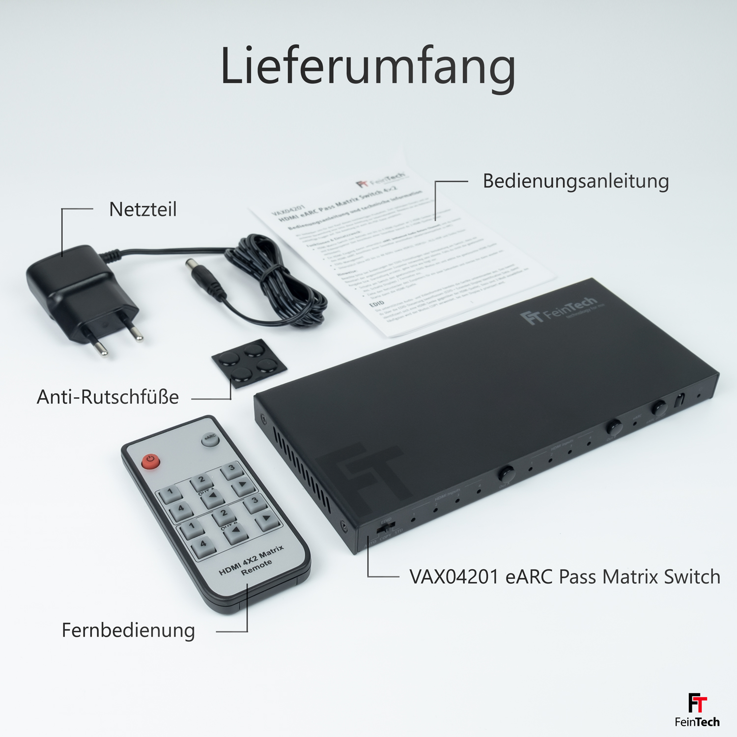 Ein schwarzes Gerät mit Zubehör wird angezeigt. Enthält Netzteil, Fernbedienung und Anweisungen.