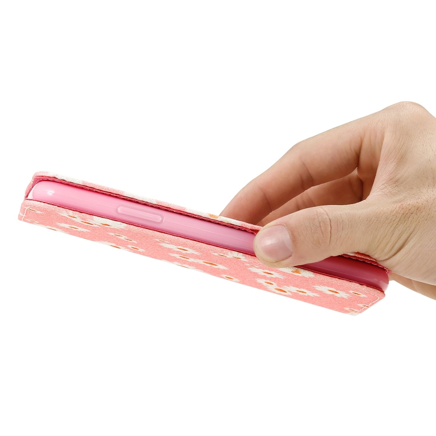 Hand hält eine rosa Handyhülle mit weißem Muster.