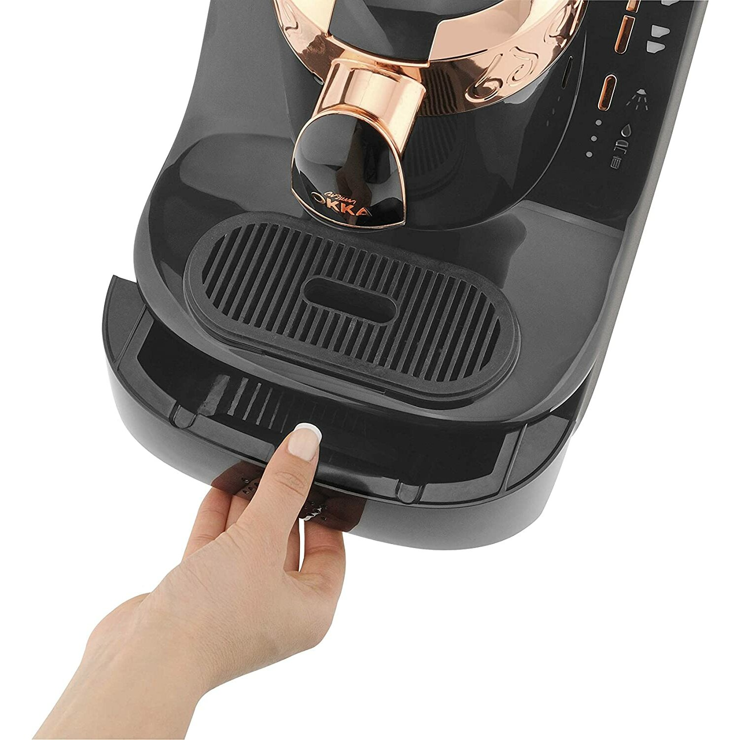 Die Hand einer Person, die ein Fach aus einer schwarzen Kaffeemaschine entfernt.