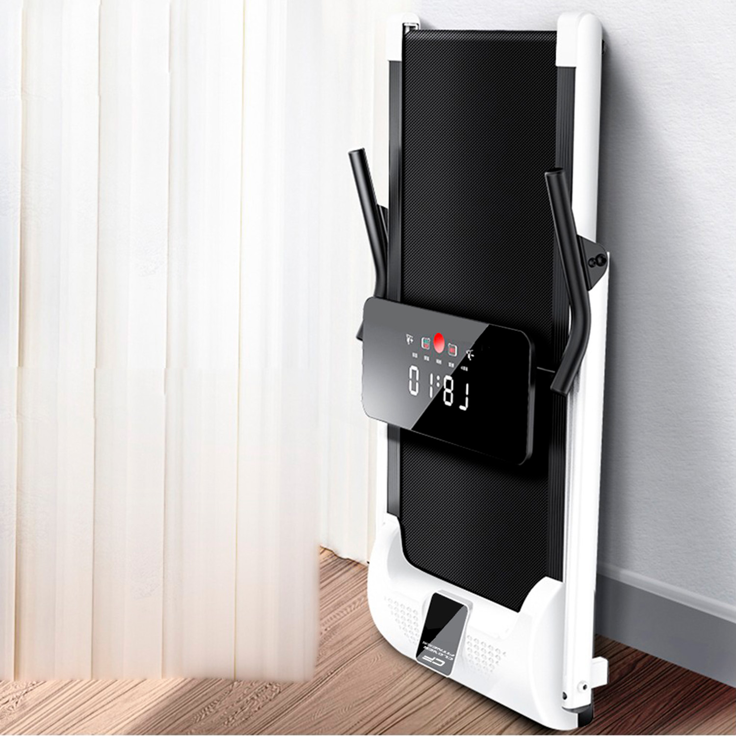 A folded, black and white treadmill is leaning against a white wall. Display shows numbers. White background.