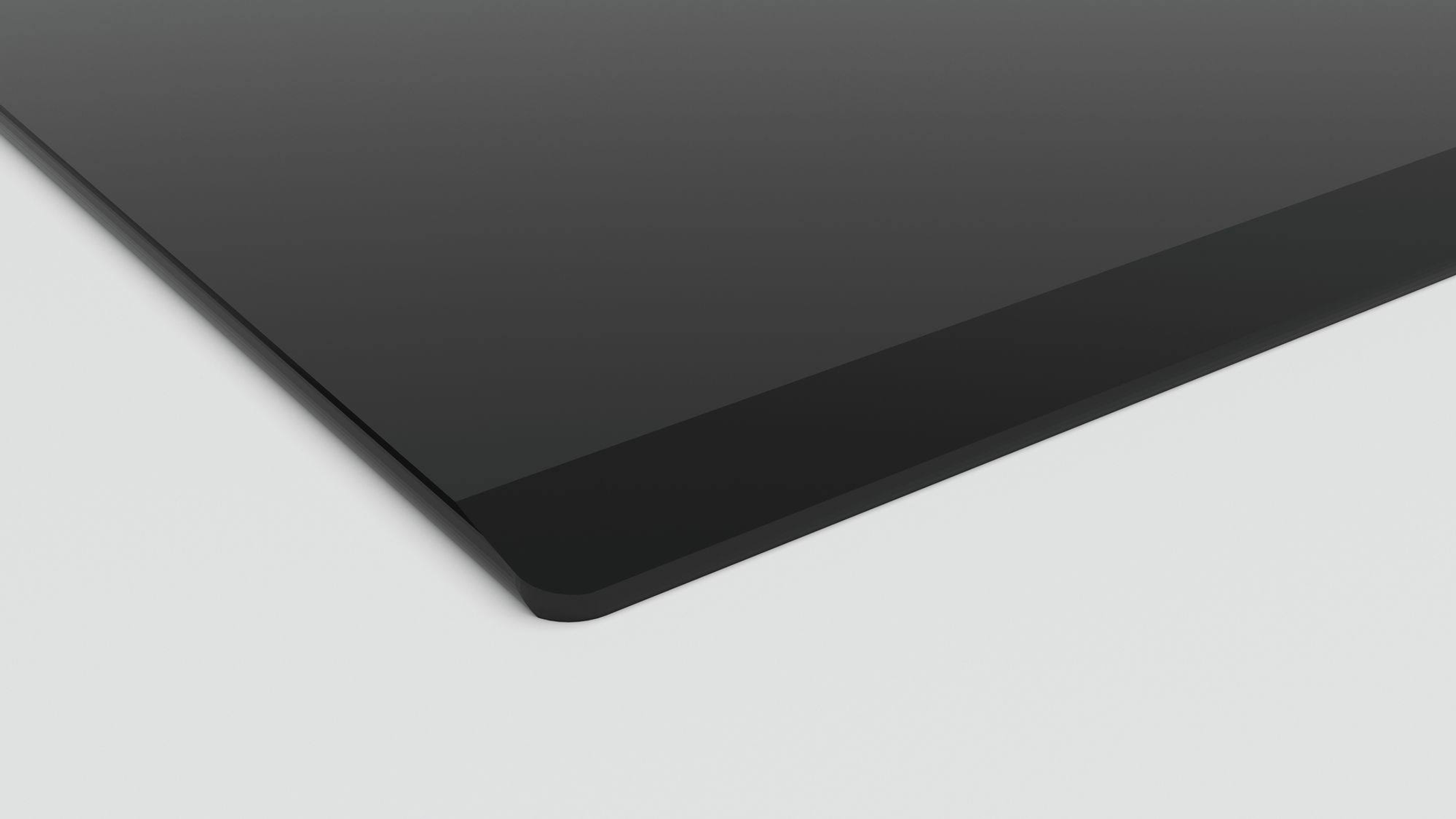 Zbliżenie czarnej, błyszczącej powierzchni, prawdopodobnie ekranu lub panelu.