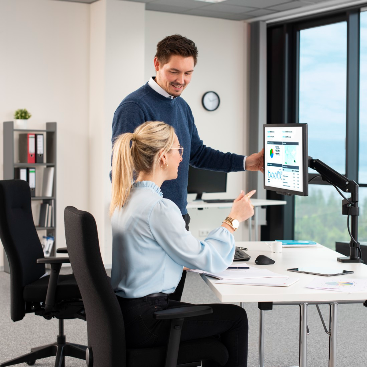 Dwie osoby patrzące na ekran komputera.