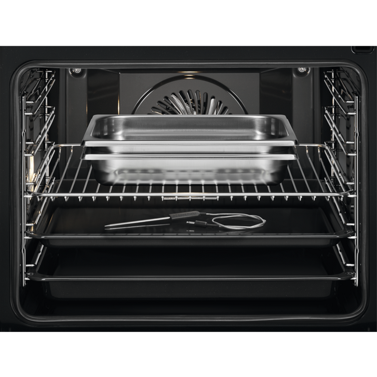 Interior de un horno con bandejas y sonda de temperatura visible. Sartenes de acero inoxidable.