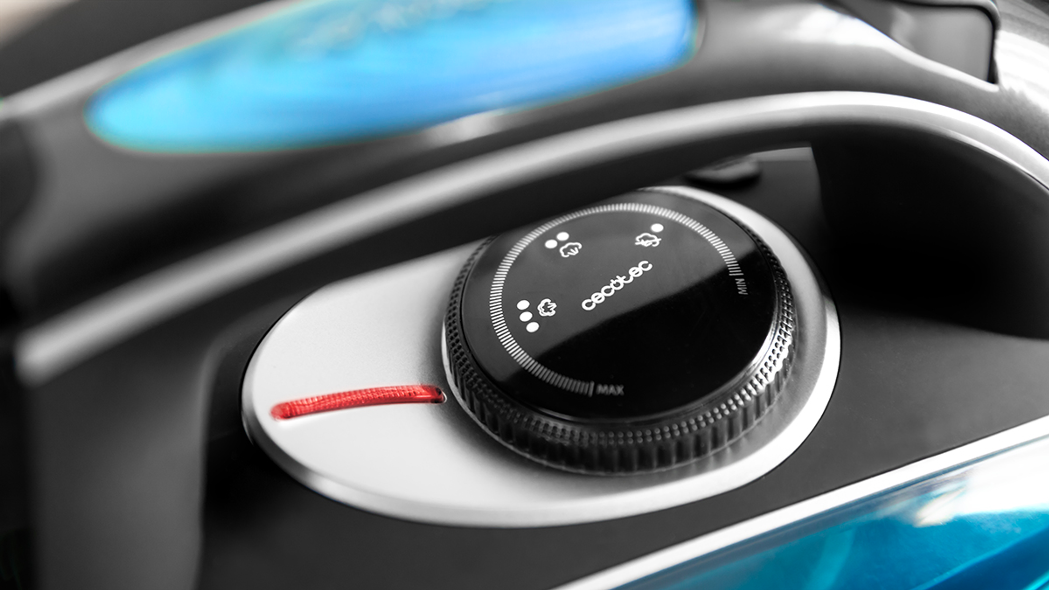 Primer plano de un dial de control de electrodomésticos negro con iconos y una línea roja.
