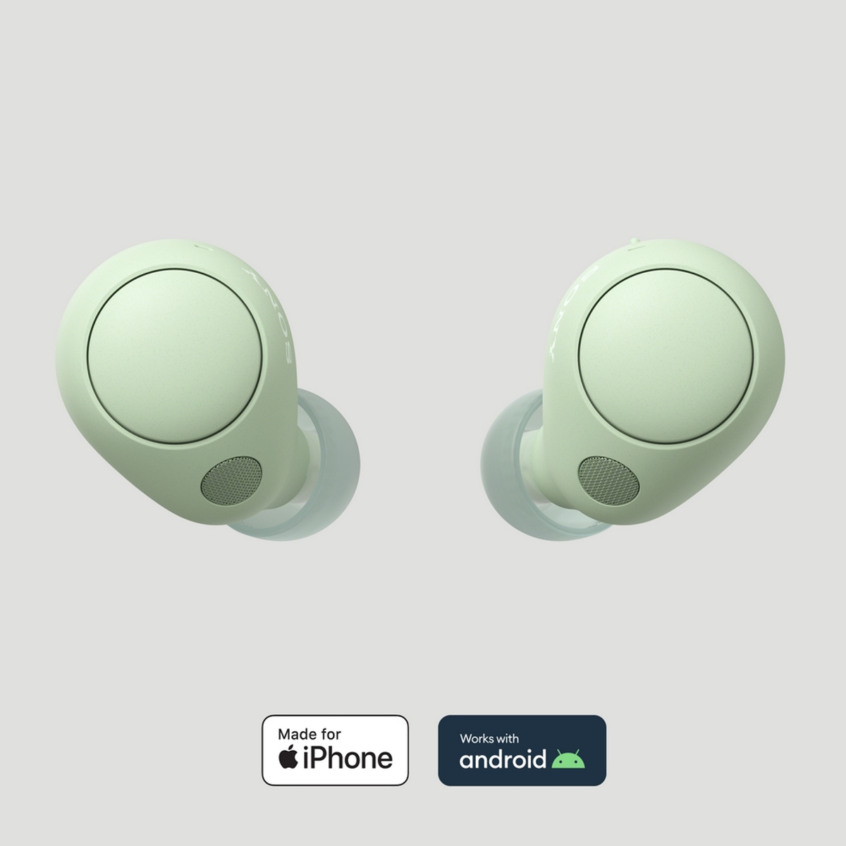 Dos auriculares verde menta. Uno tiene una pequeña abertura para el altavoz.
