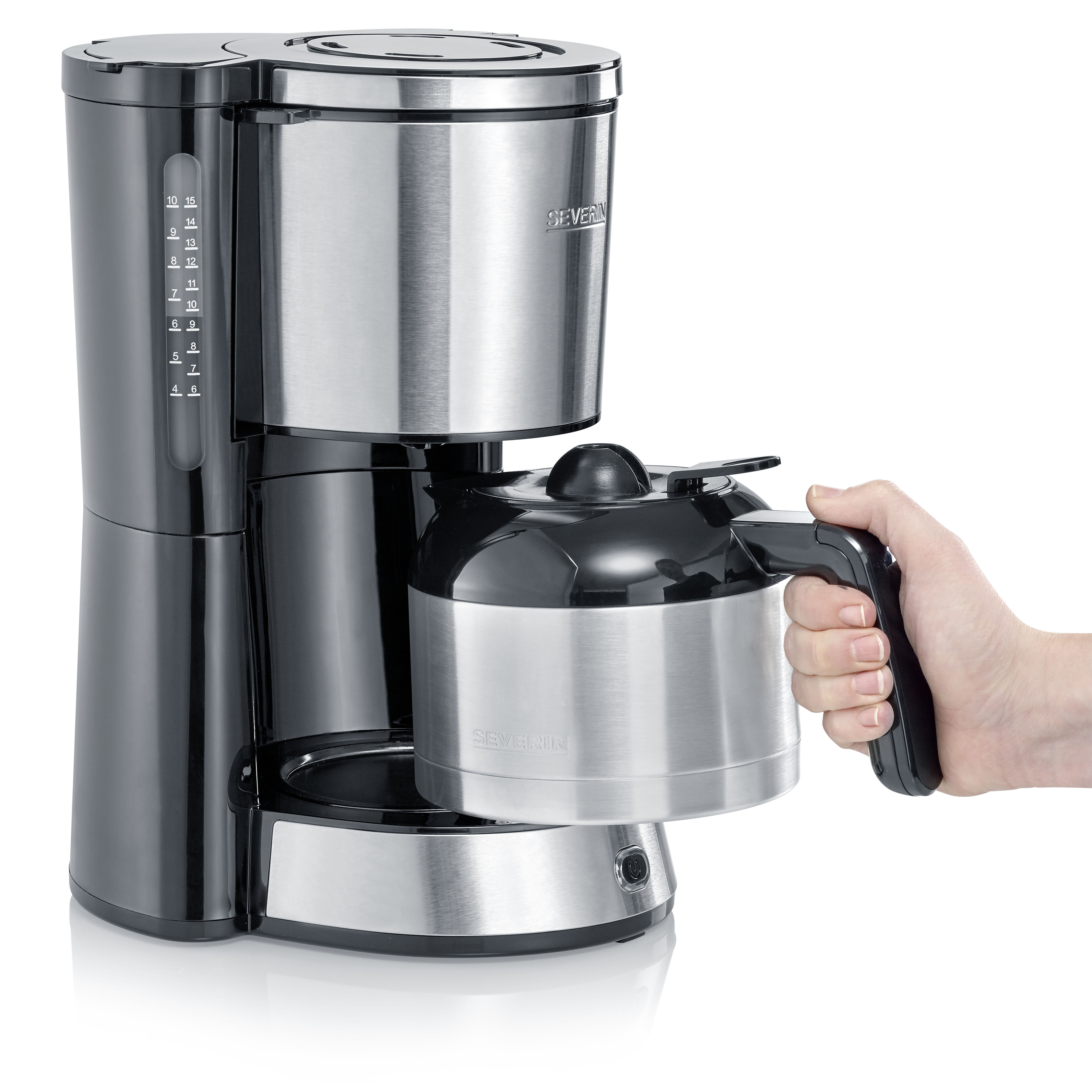 Una macchina per il caffè nera e argento. Una mano tiene la caffettiera.
