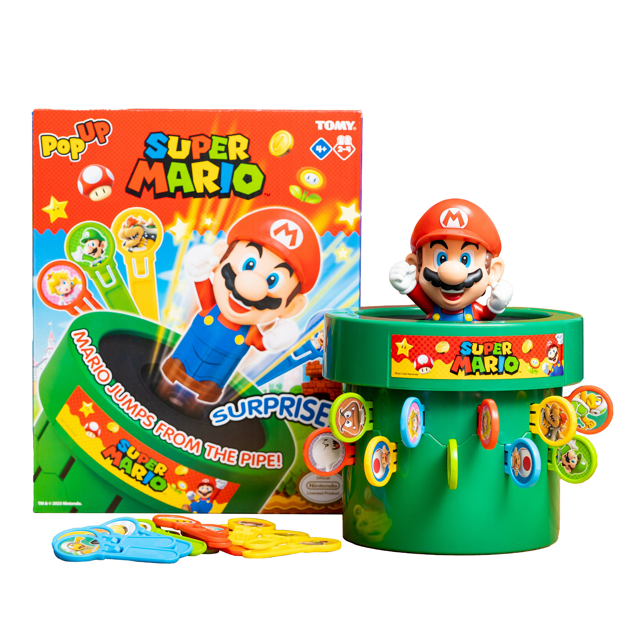Set di gioco Super Mario. Mario esce da un tubo verde. Scatola e pezzi del gioco visibili.