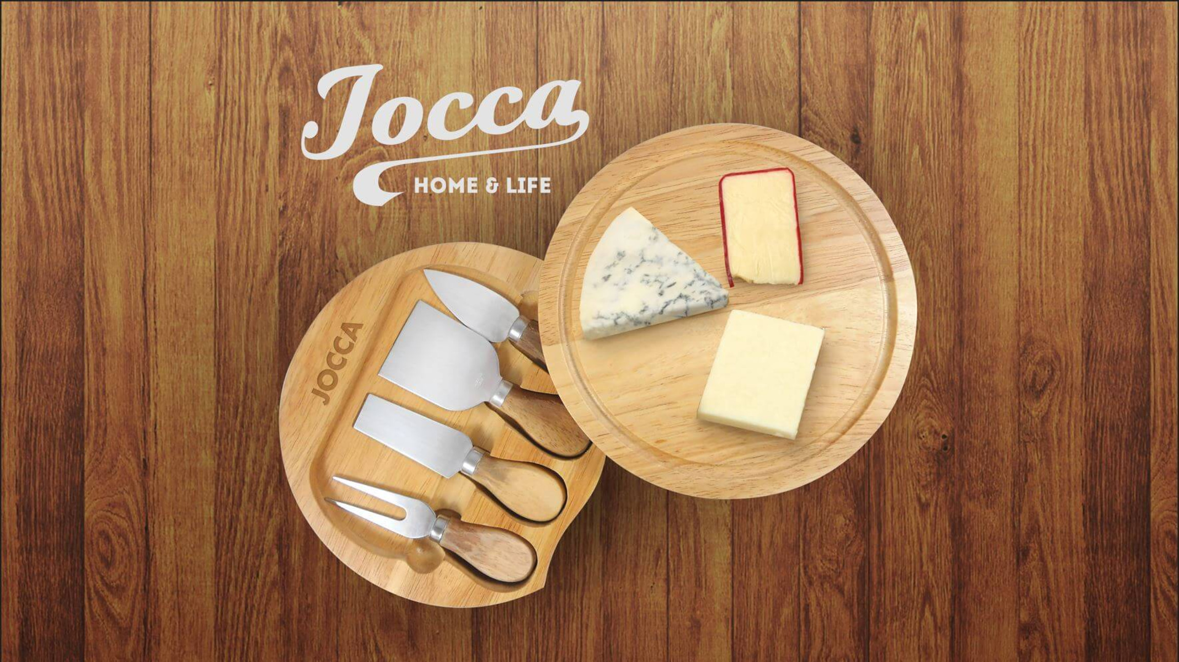 Käsebrett aus Holz mit Käse und Messern, auf Holzoberfläche mit Logo.
