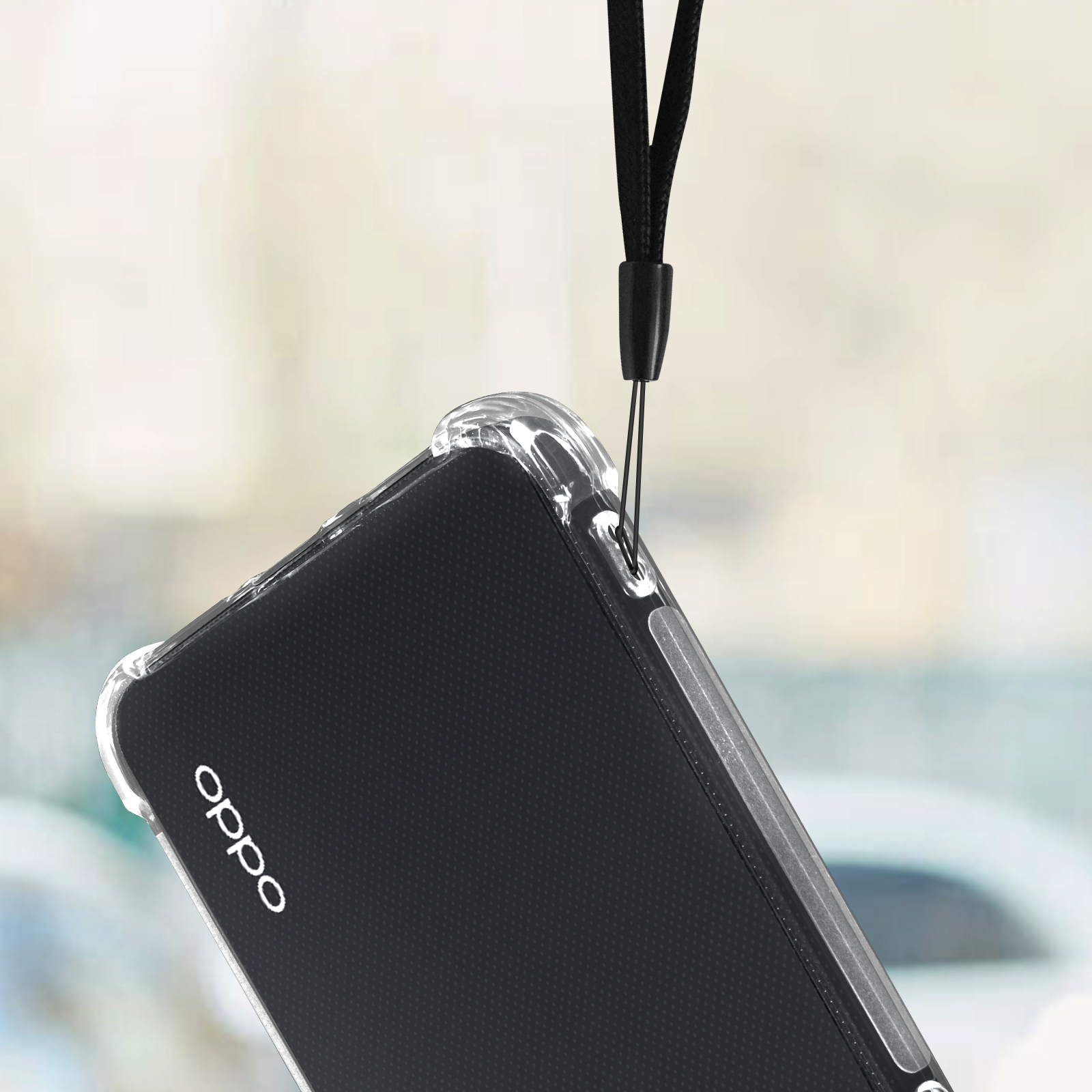 Una custodia trasparente per telefono con un telefono nero all'interno. La custodia ha un cordino.