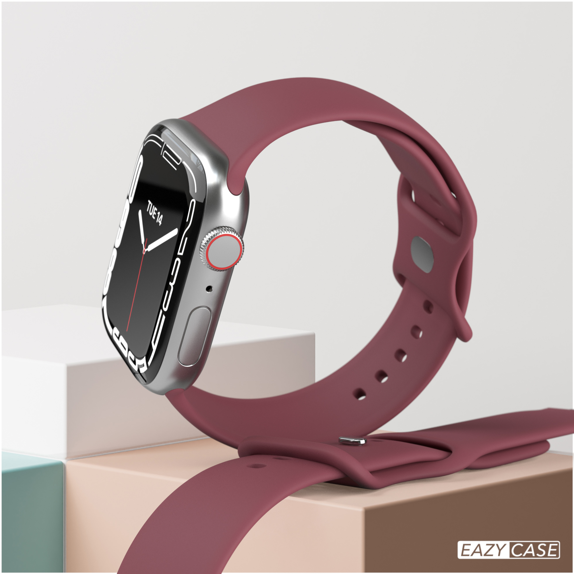 Burgunderfarbene Smartwatch mit passendem Armband, vor neutralem Hintergrund mit geometrischen Formen.