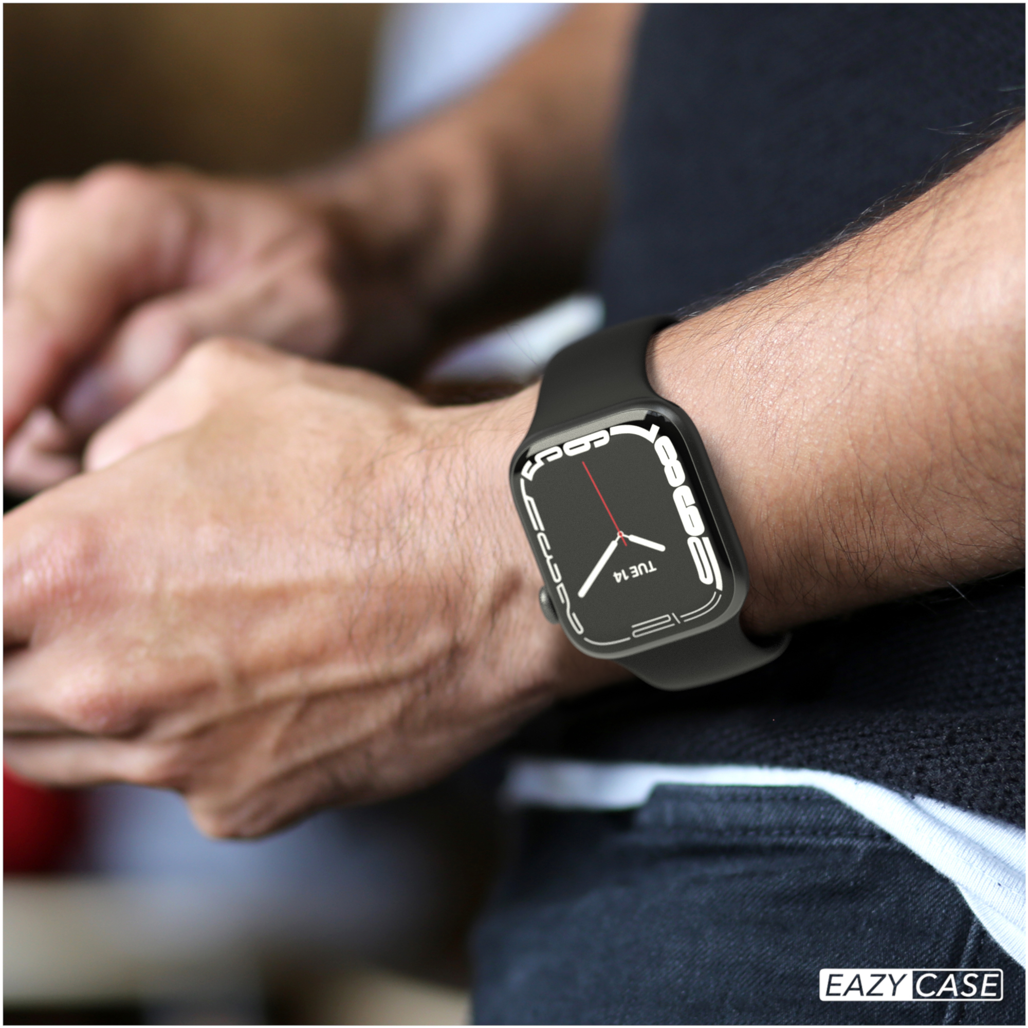 Person trägt schwarze Smartwatch, die Zeit und Datum anzeigt. Schwarzes Hemd sichtbar.