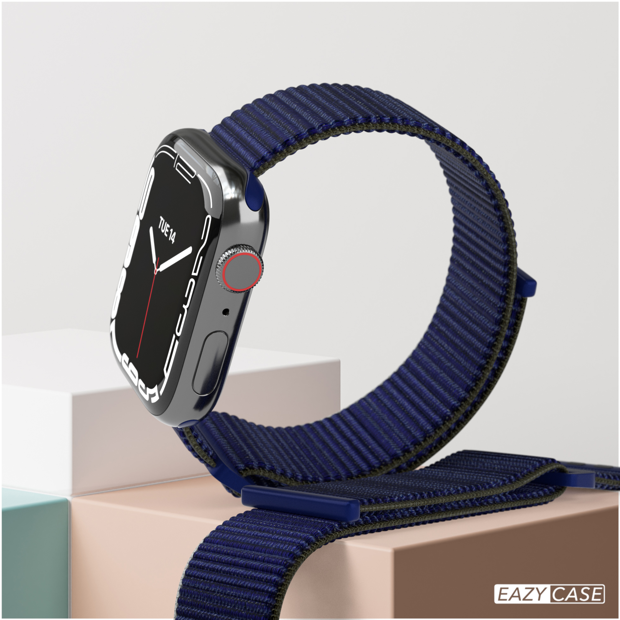 Eine Smartwatch mit dunkelblauem Armband. Sie wird auf einer weißen und beigen Oberfläche angezeigt.