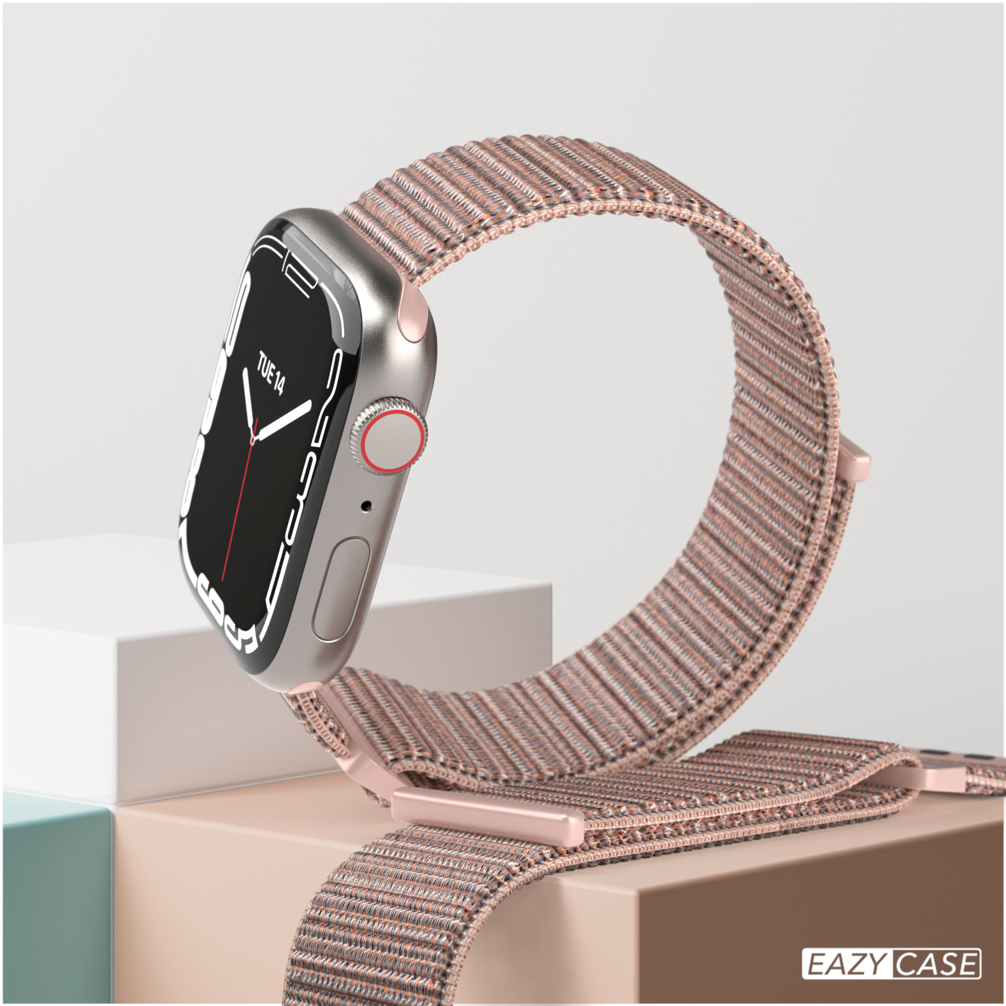 Eine silberne Smartwatch mit pinkfarbenem Armband. Es liegt auf einer beige-weißen Oberfläche mit Markenname.