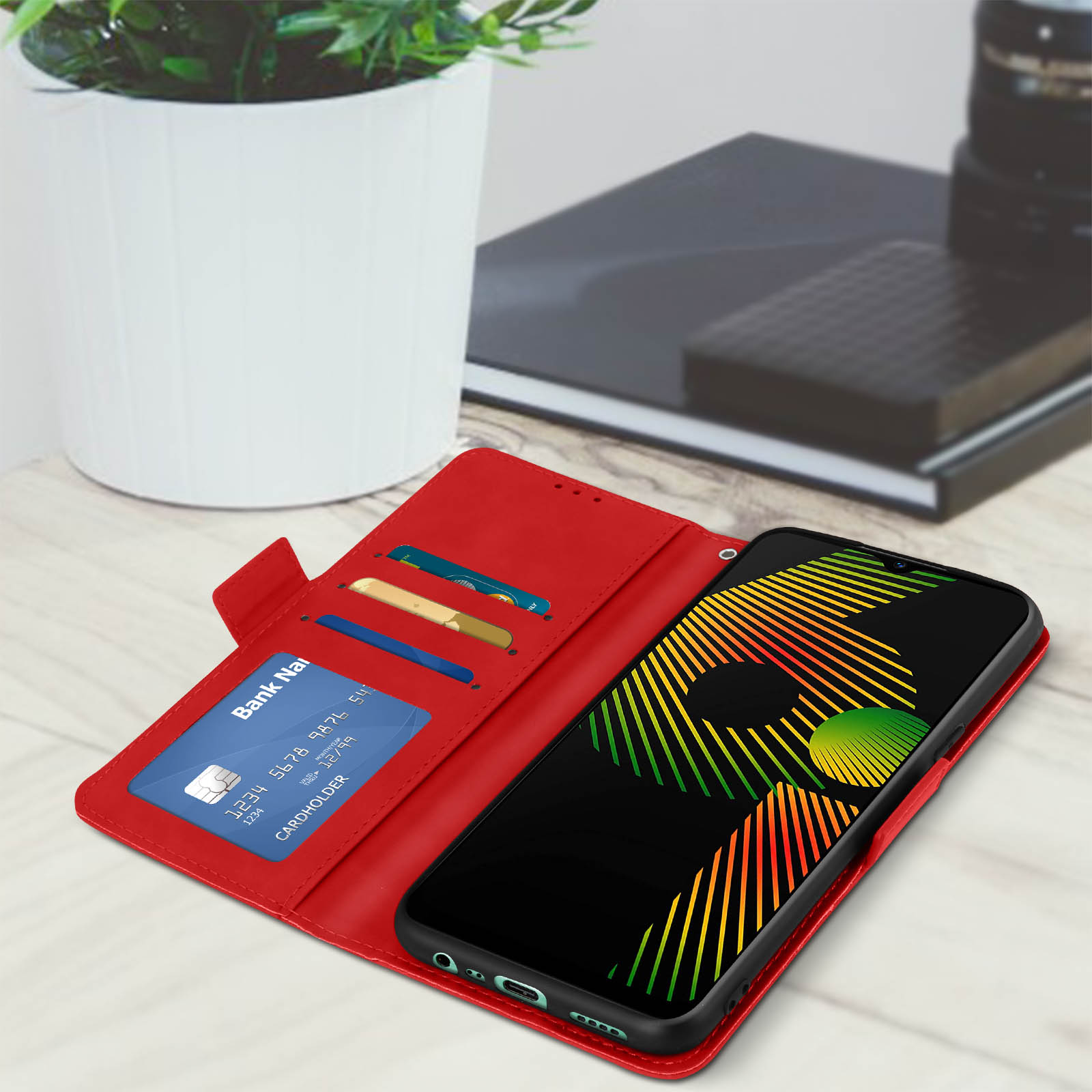 Custodia per telefono rossa aperta, che mostra un telefono e una carta di credito.