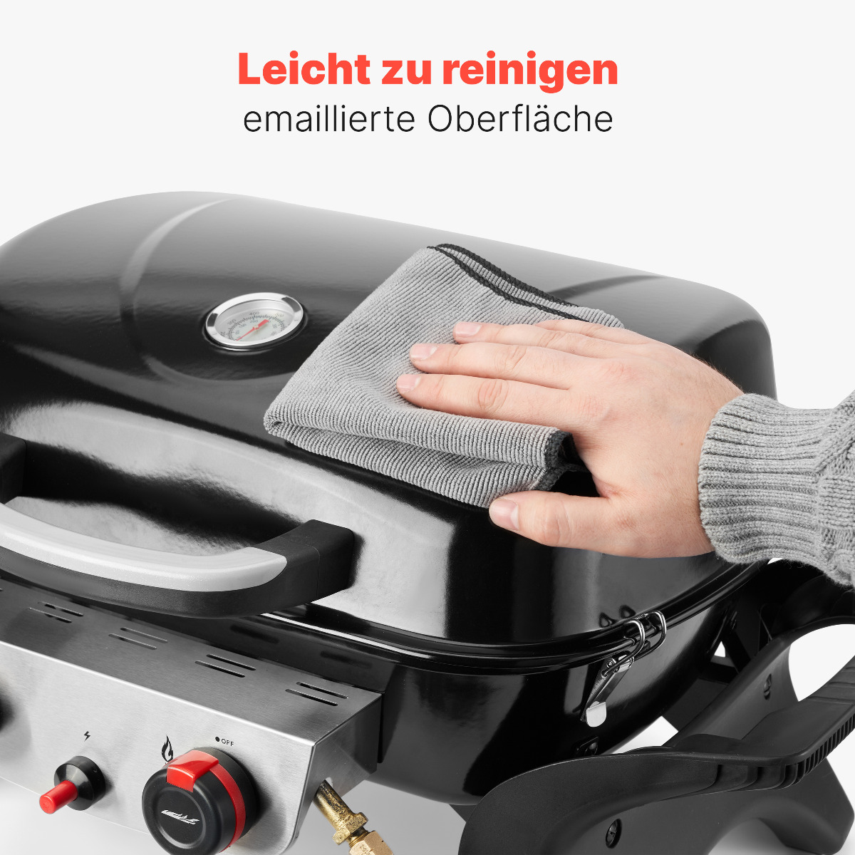 Eine Hand wischt einen schwarzen Grill ab. Der Text sagt: leicht zu reinigen, emaillierte Oberfläche.