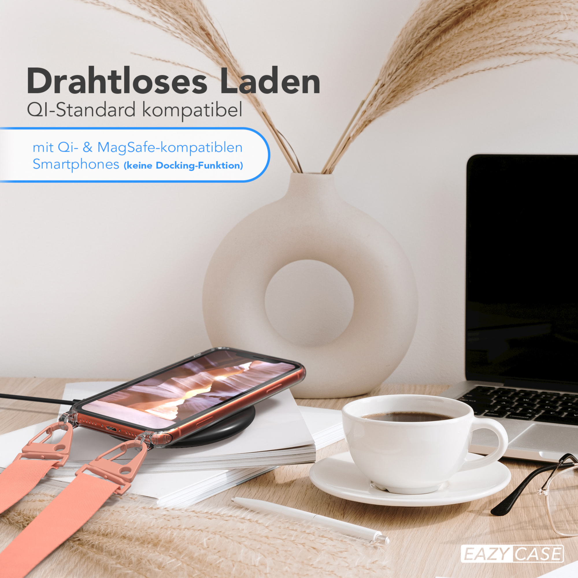 Telefon auf kabellosem Ladegerät, Kaffee und Blumen. Der Riemen ist orange.
