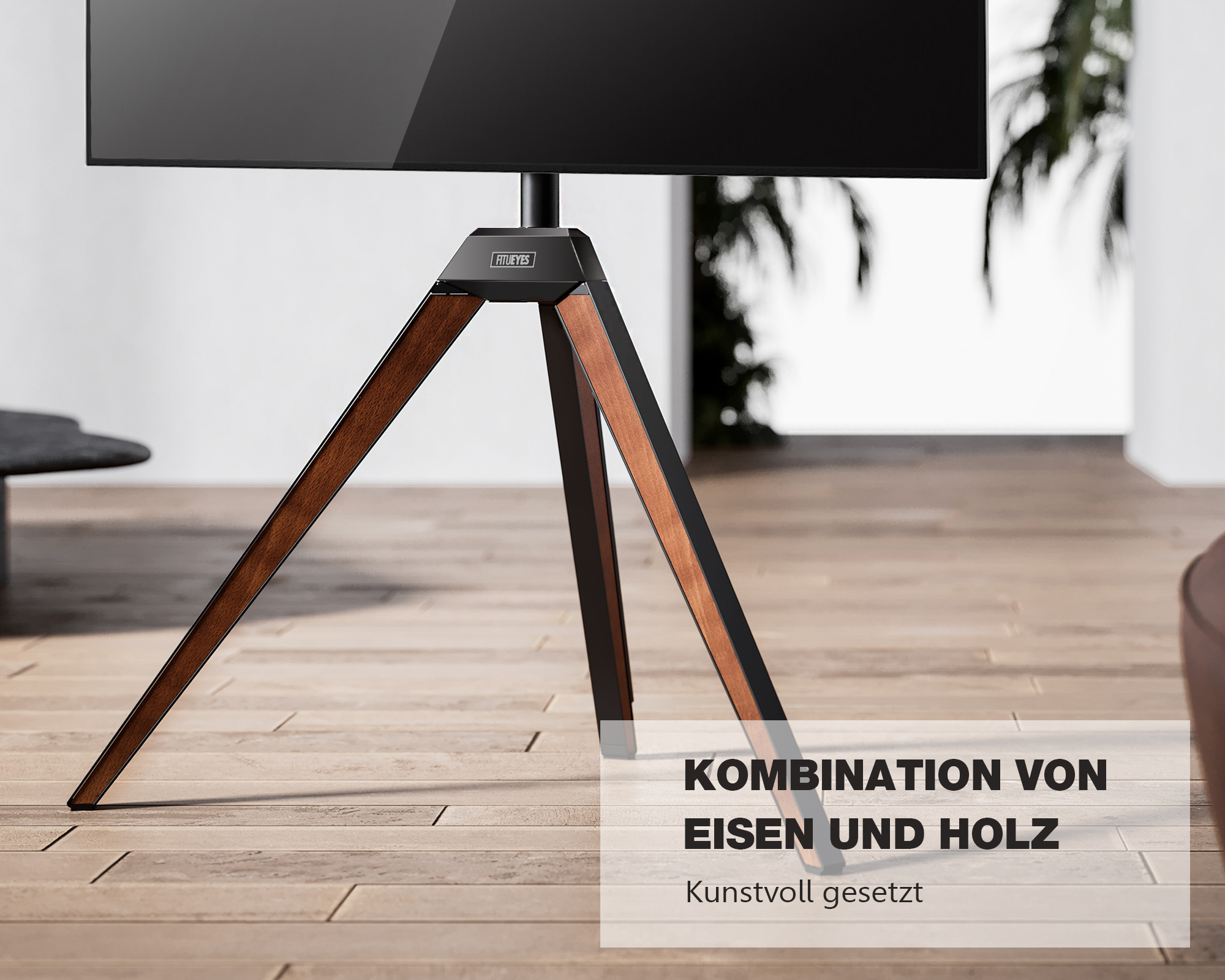 Ein TV-Ständer mit Holzbeinen und einer schwarzen Oberseite. Die Beine sind braun, der Hintergrund ist ein Raum.