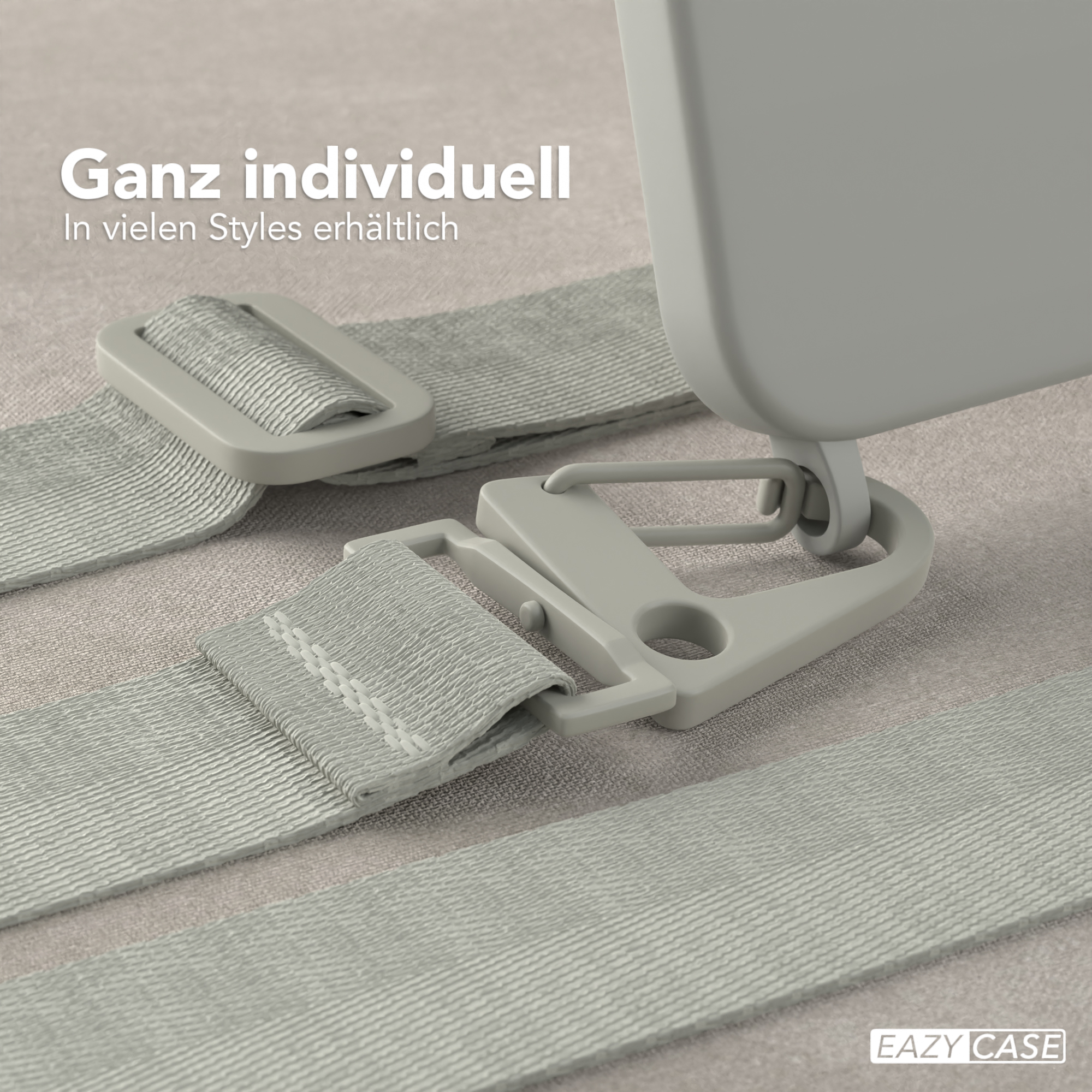 Nahaufnahme einer Handyhülle und eines Trageriemens. Die Hülle ist grau, mit grauem Riemen und Schnalle.