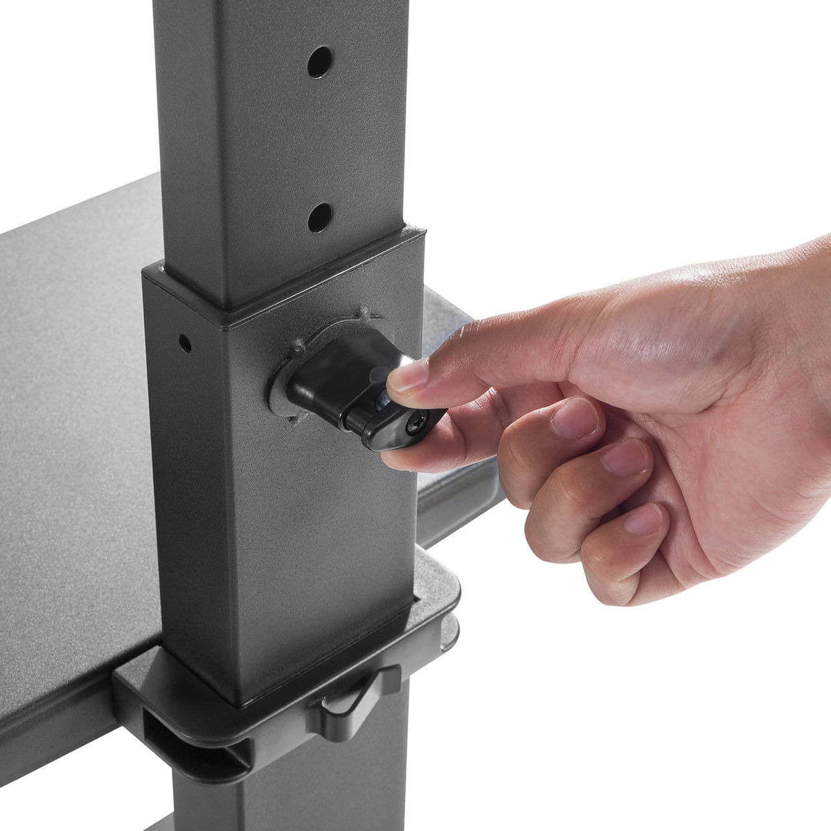 Hand presses a black knob on a gray metal stand. Close-up shot.