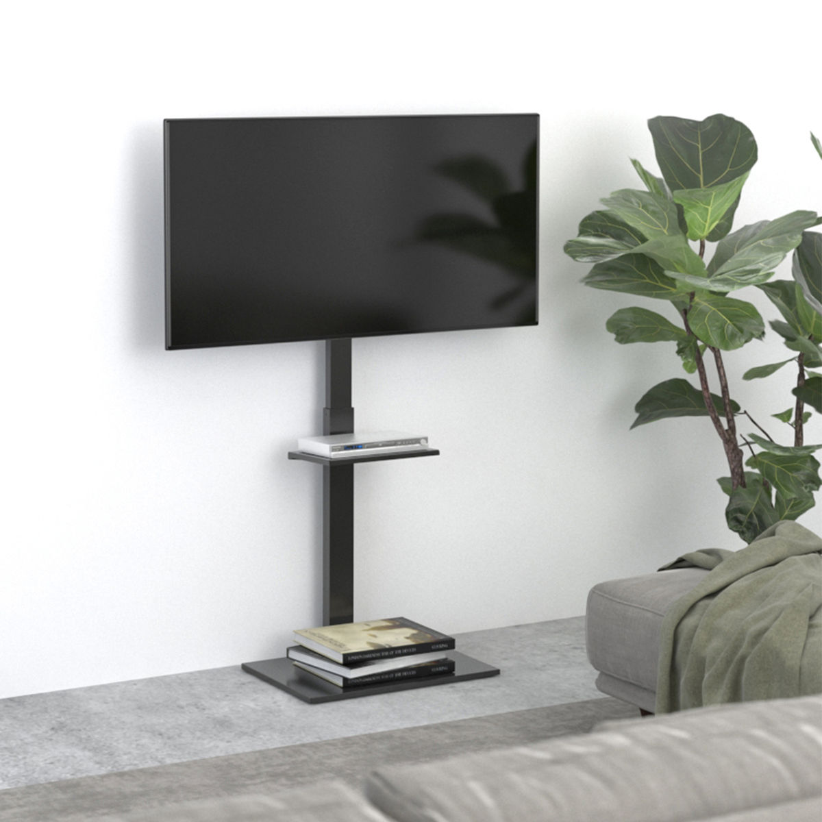A black TV is mounted on a black stand against a white wall. Books are on a shelf below the TV.