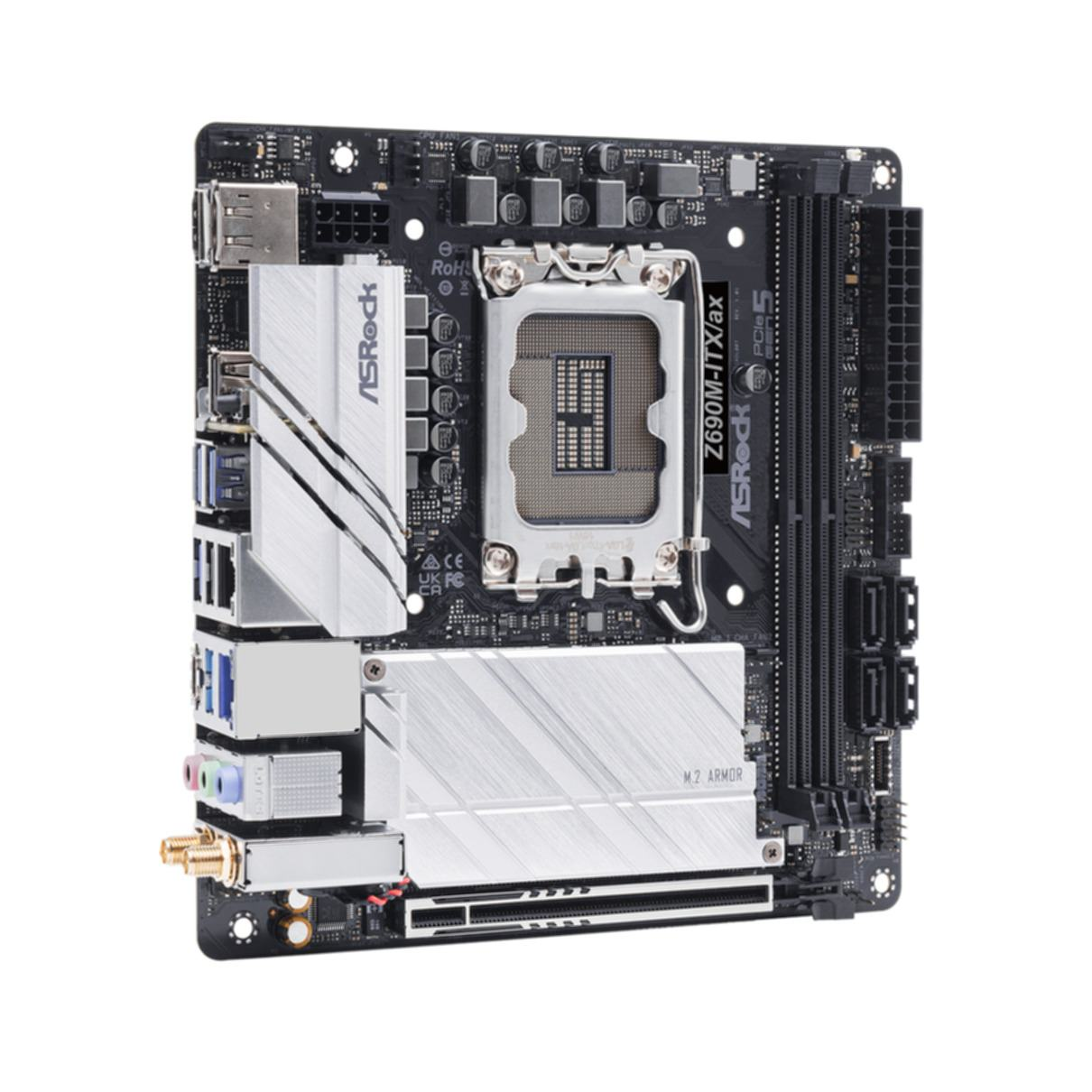 Scheda madre ASRock nera e argento su superficie bianca, con vari componenti.