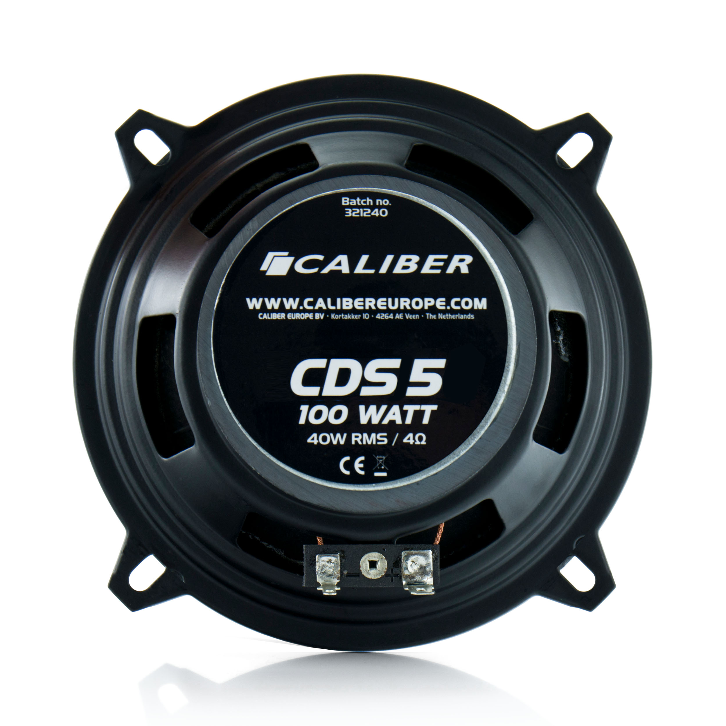 Black speaker with a silver center. The speaker is on a white surface.