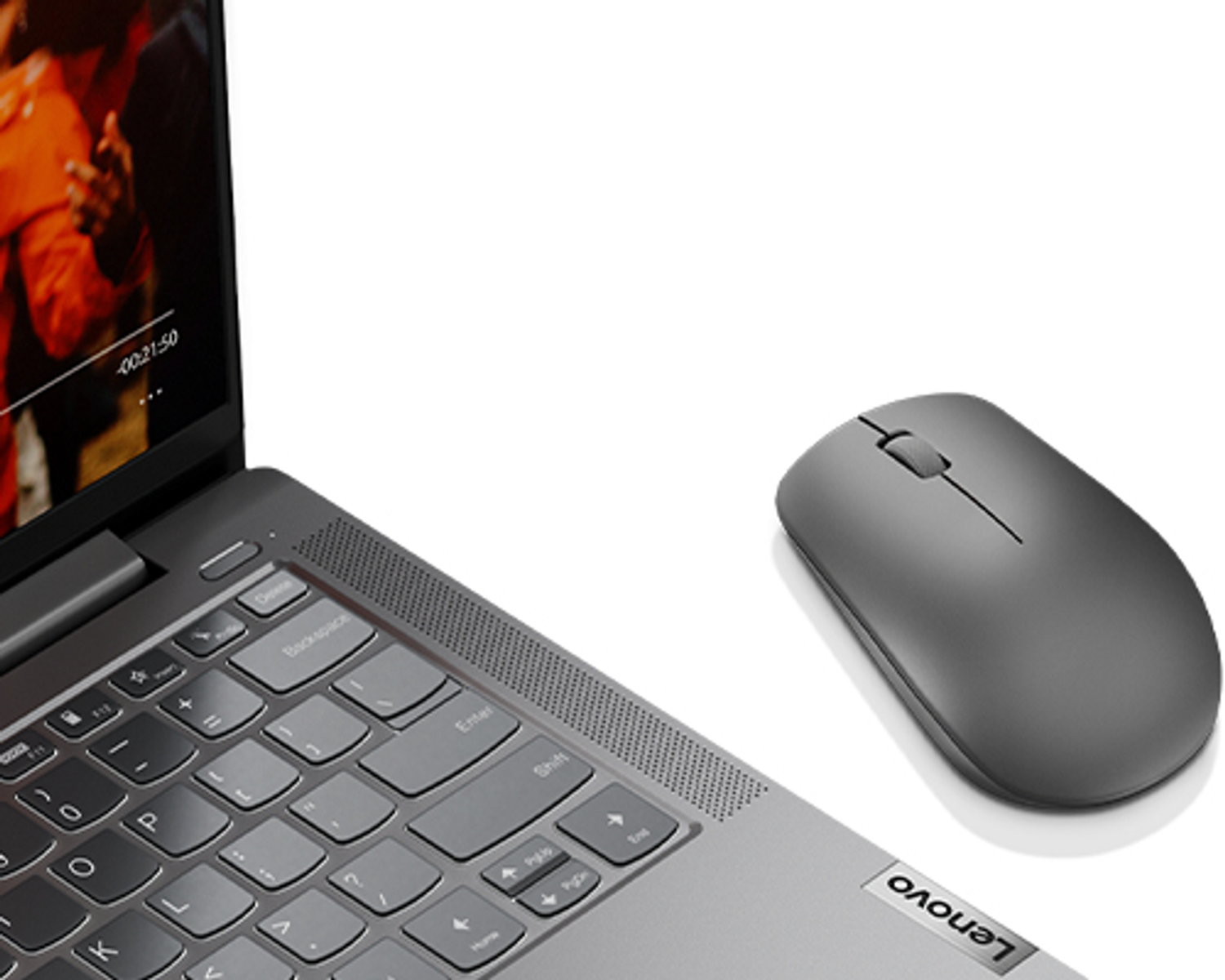 Laptop keyboard and screen displaying video, gray mouse on the right, white background.