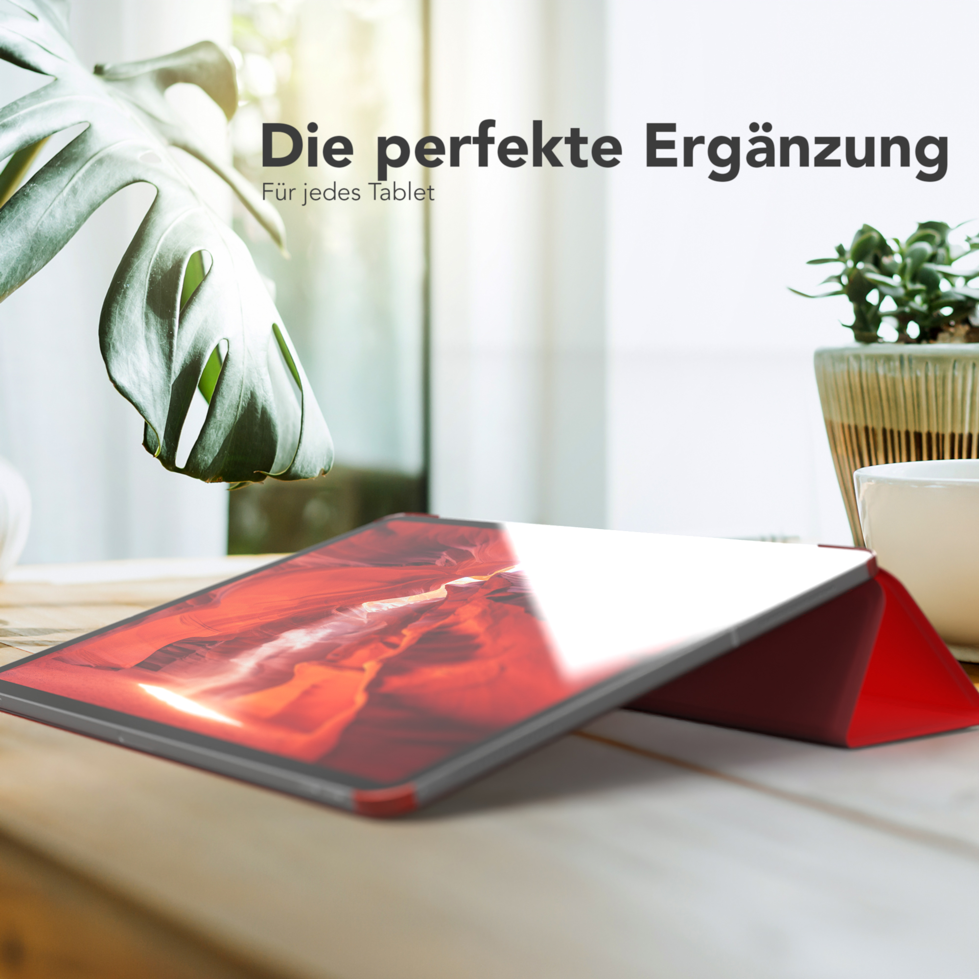 Tablet in roter Hülle auf Holzoberfläche, mit Text "Die perfekte Ergänzung" (Die perfekte Ergänzung).
