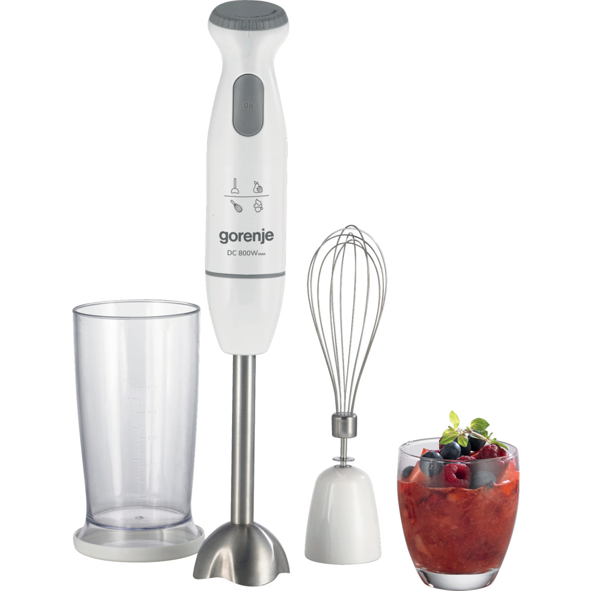 Witte staafmixer met accessoires: beker, garde en een glas met fruit.