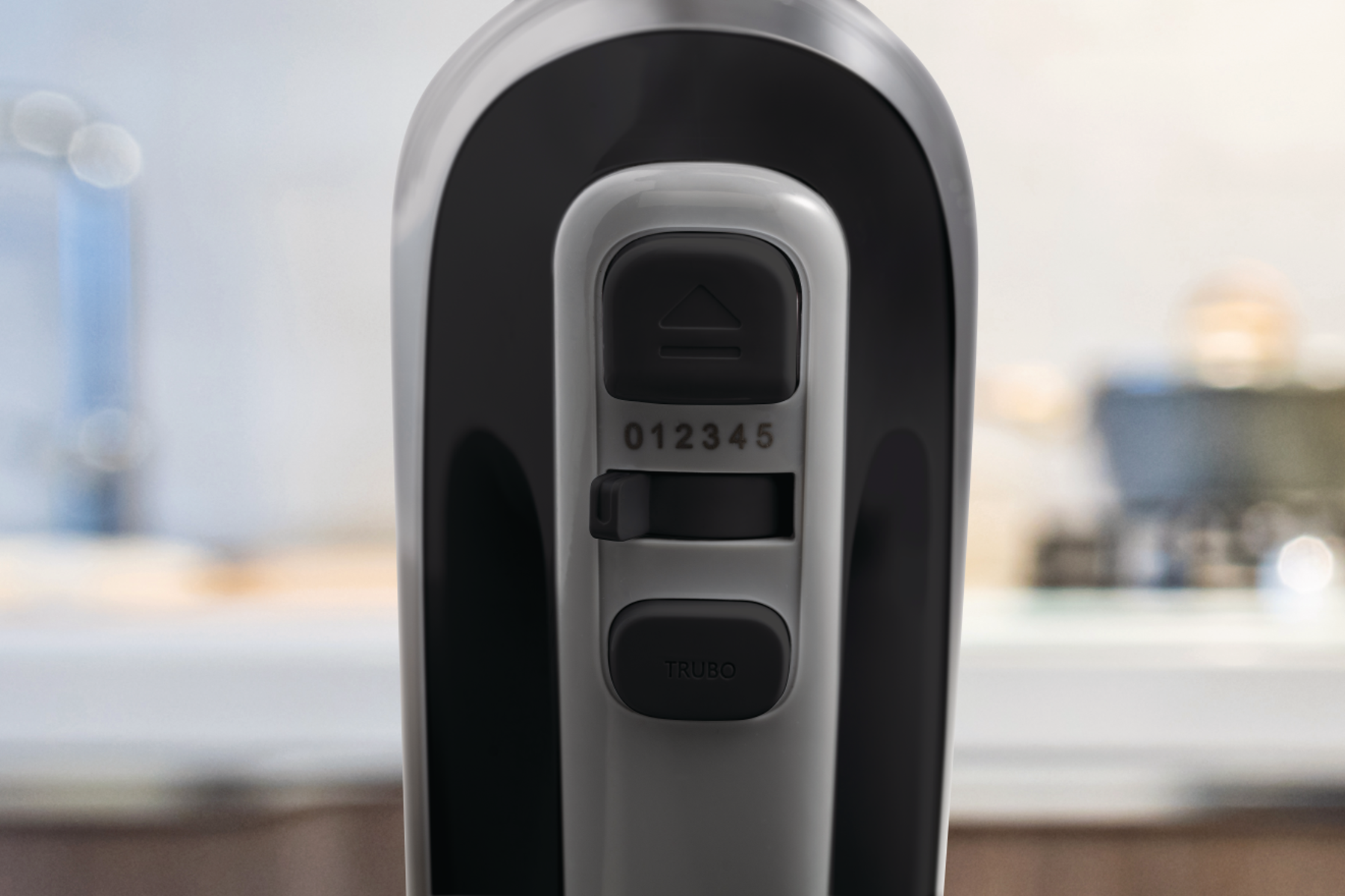 Nahaufnahme des Bedienfelds eines elektrischen Mixers, das Geschwindigkeitseinstellungen und eine Turbotaste zeigt.