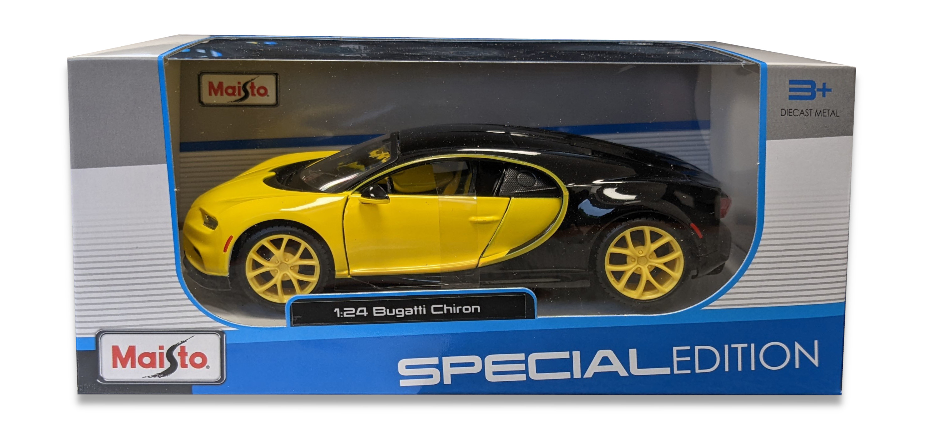 Ein Spielzeugauto in einer Box. Das Auto ist gelb und schwarz. Die Box hat Text.