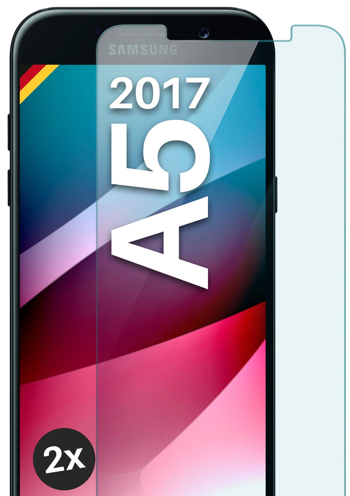 Handy-Display mit Displayschutz. Weißer Text „A5 2017“. Der Hintergrund ist pink.