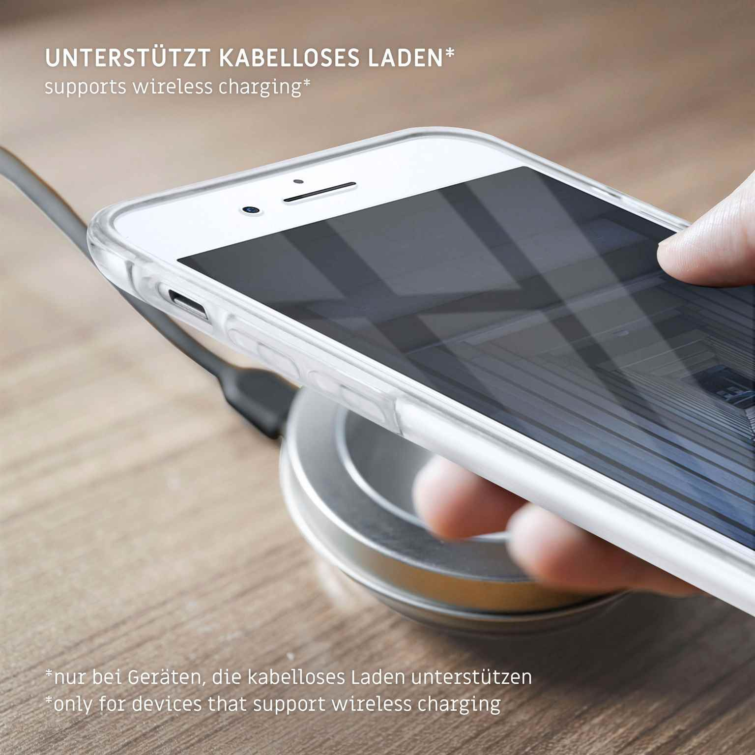 Telefon in klarer Hülle auf kabellosem Ladegerät. Schwarzer Hintergrund. Ladesymbol.