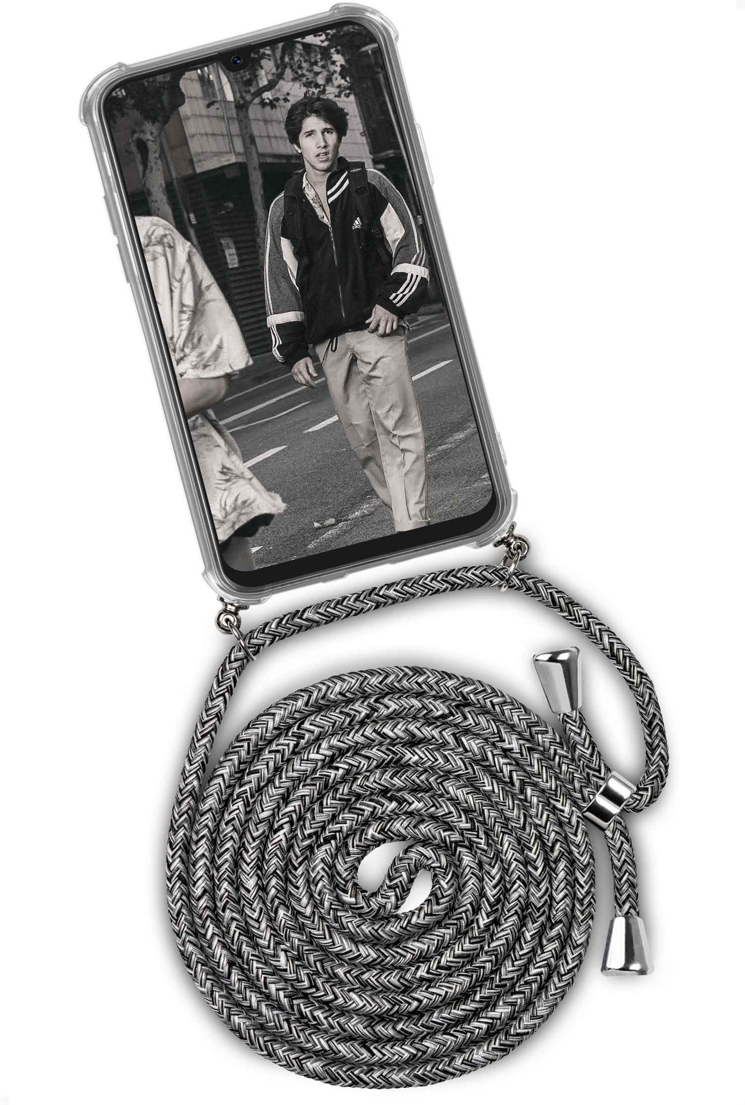 Telefon mit grauem Kordel. Zeigt einen Mann mit Jacke auf der Straße.
