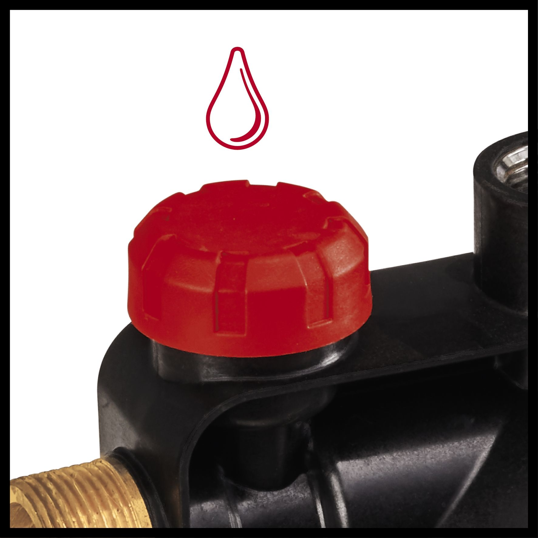 Czerwona nasadka na czarnym urządzeniu, z czerwoną ikoną kropli powyżej, ujęcie z bliska.