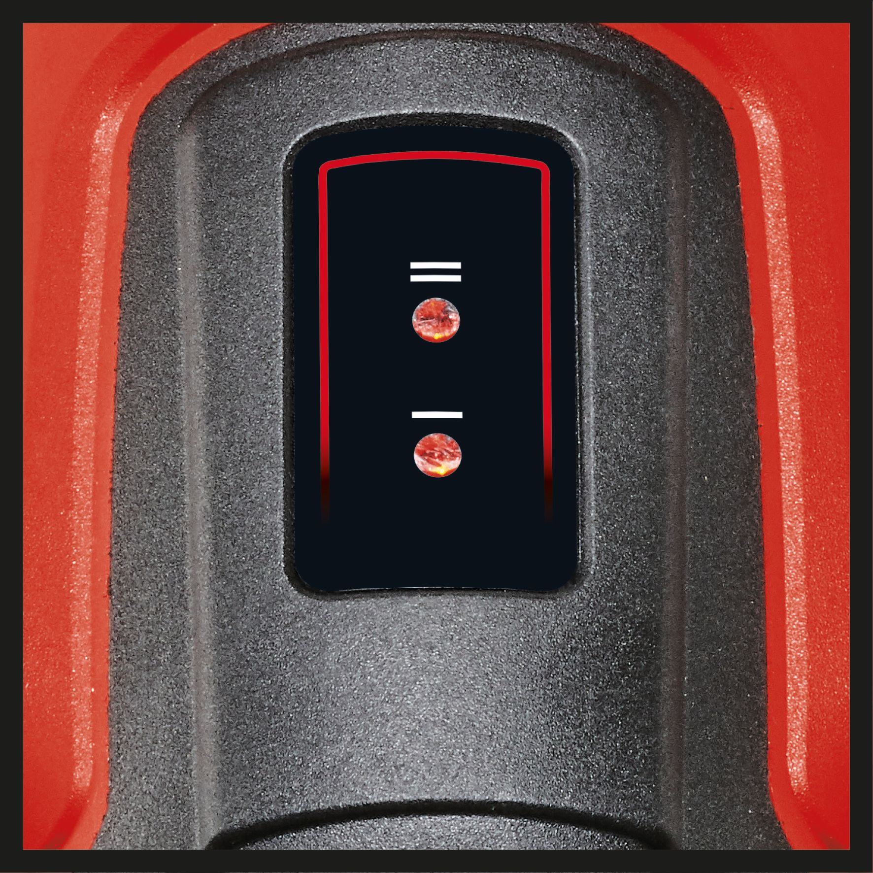 Czerwono-czarne urządzenie elektroniczne z czarnym ekranem z dwoma okrągłymi światłami.