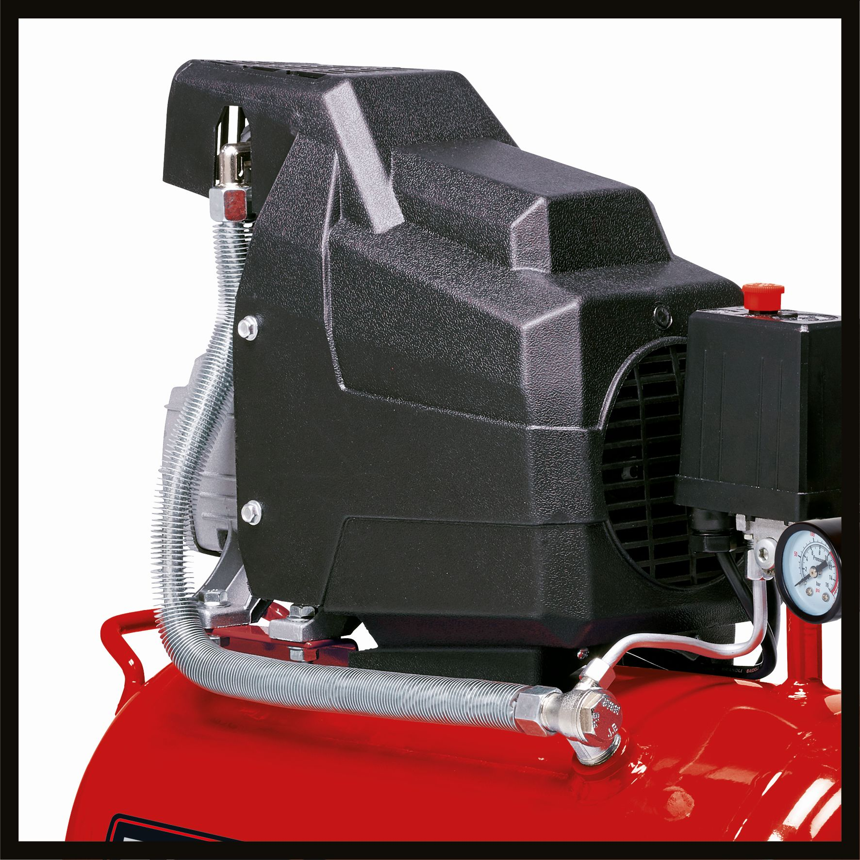 Primo piano di un compressore d'aria rosso con copertura nera e manometro.