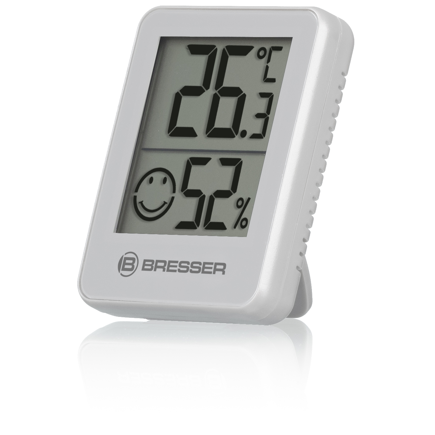 Termómetro digital blanco que muestra 26,3°C y 52%. Se muestra una carita sonriente. Fondo blanco.